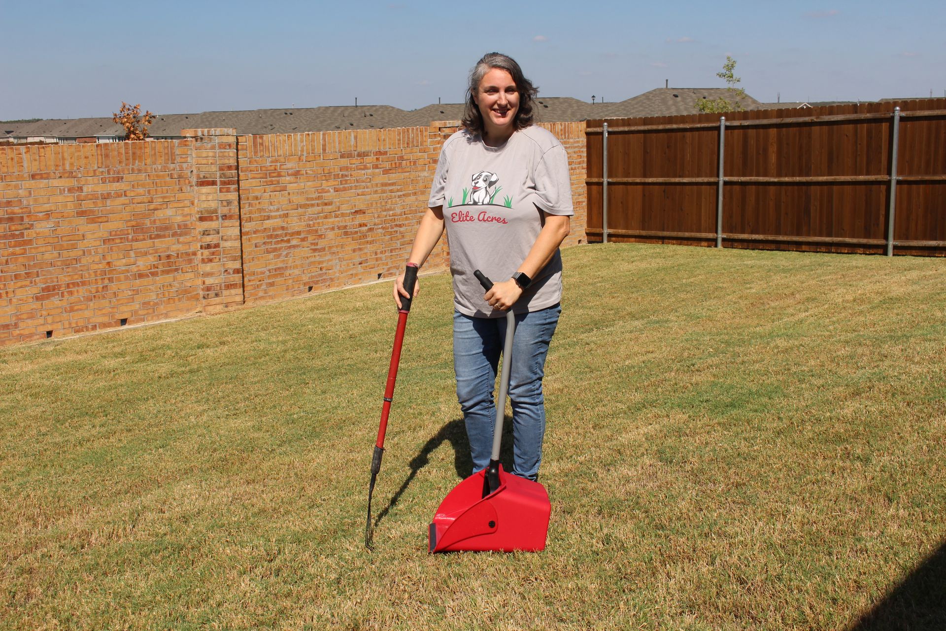 A woman picking-up the dry leaves.