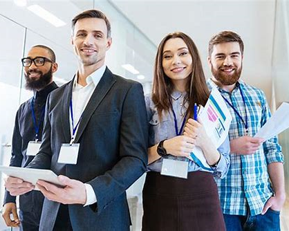 Four people standing next to each other in an office, an image for Validation and Quality Assurance staff augmentation