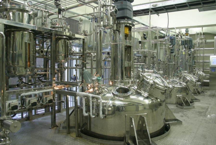 A large room filled with lots of stainless-steel bioreactors, an image for Cleaning Validation