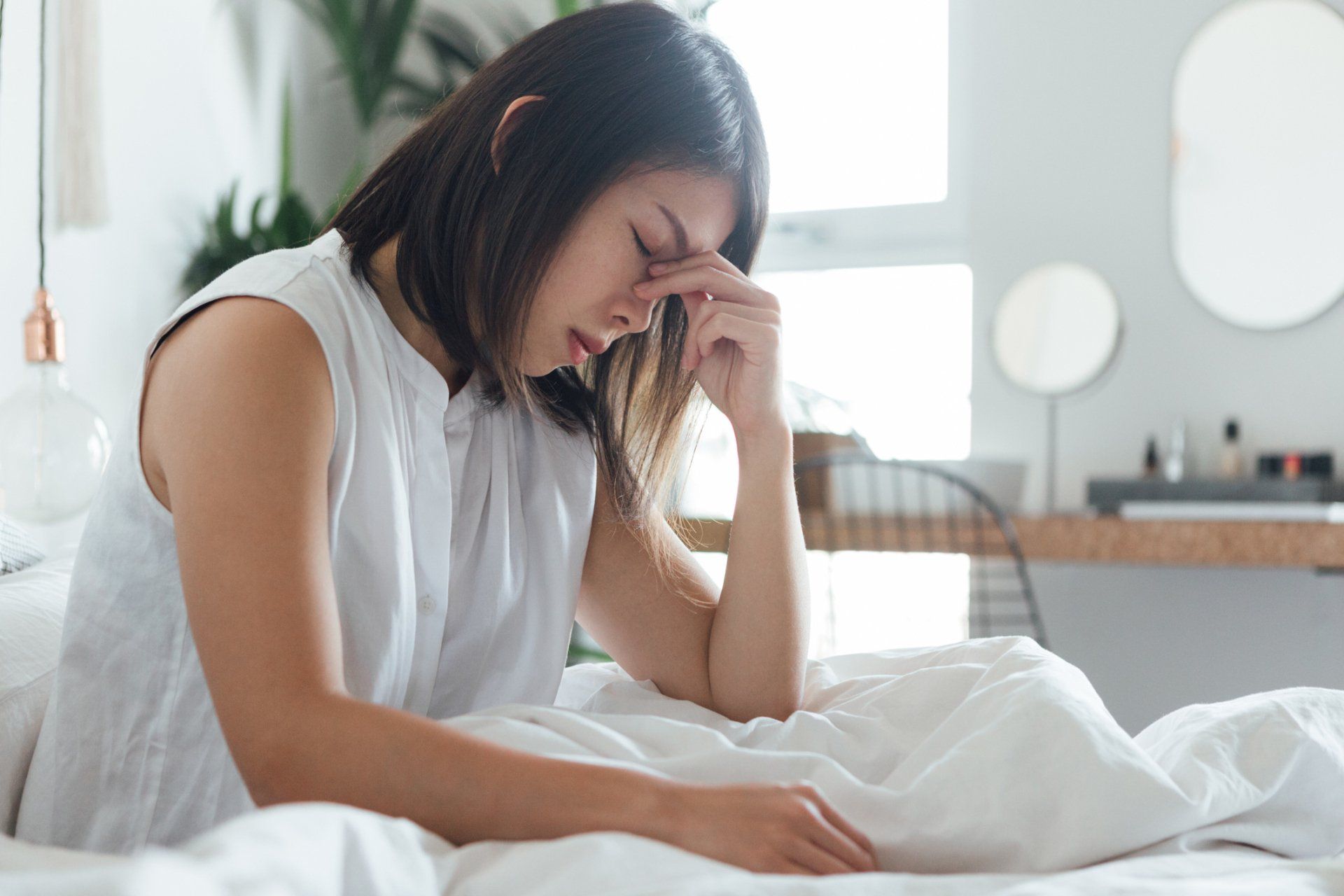 Woman in bed having a headache | Colorado Springs, CO | The Partridge Family Practice