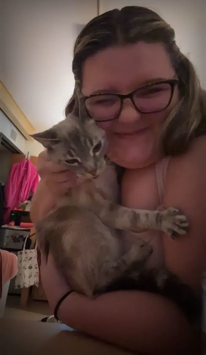 Old photo of Southeast School of Dance instructor Autumn Harper holding her cat.