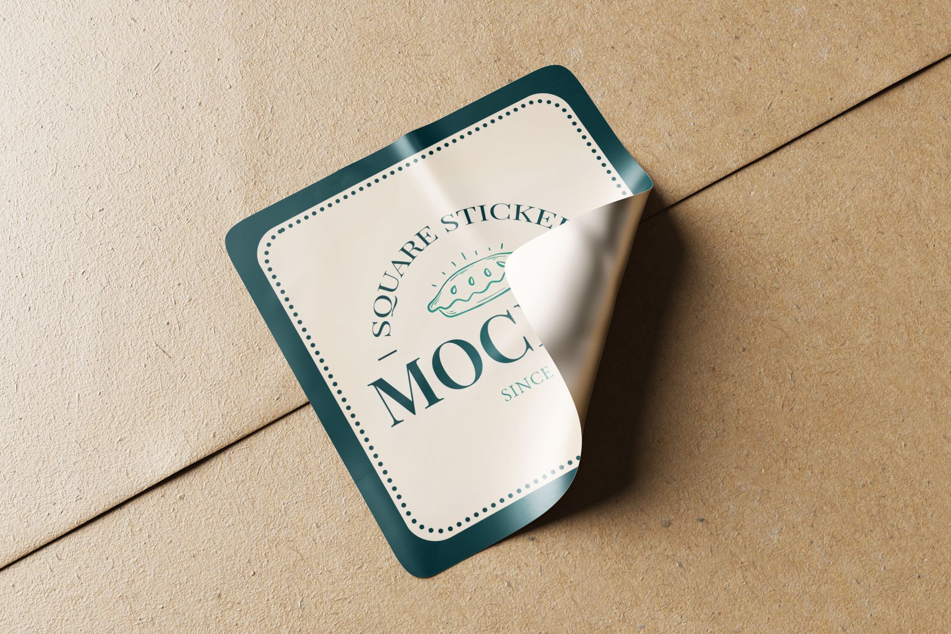 Square sticker, partially peeled, with teal border and cream center on cardboard.
