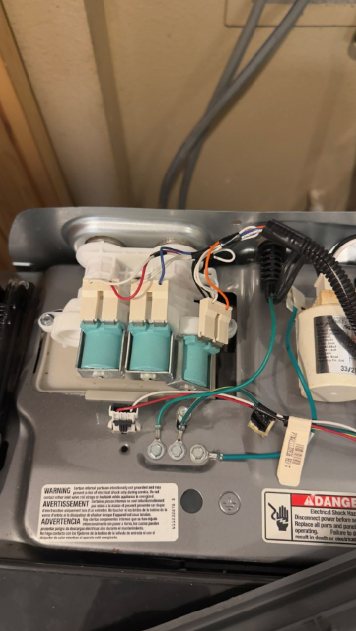 Open electrical device with wires, coils, and components mounted inside a metal housing.