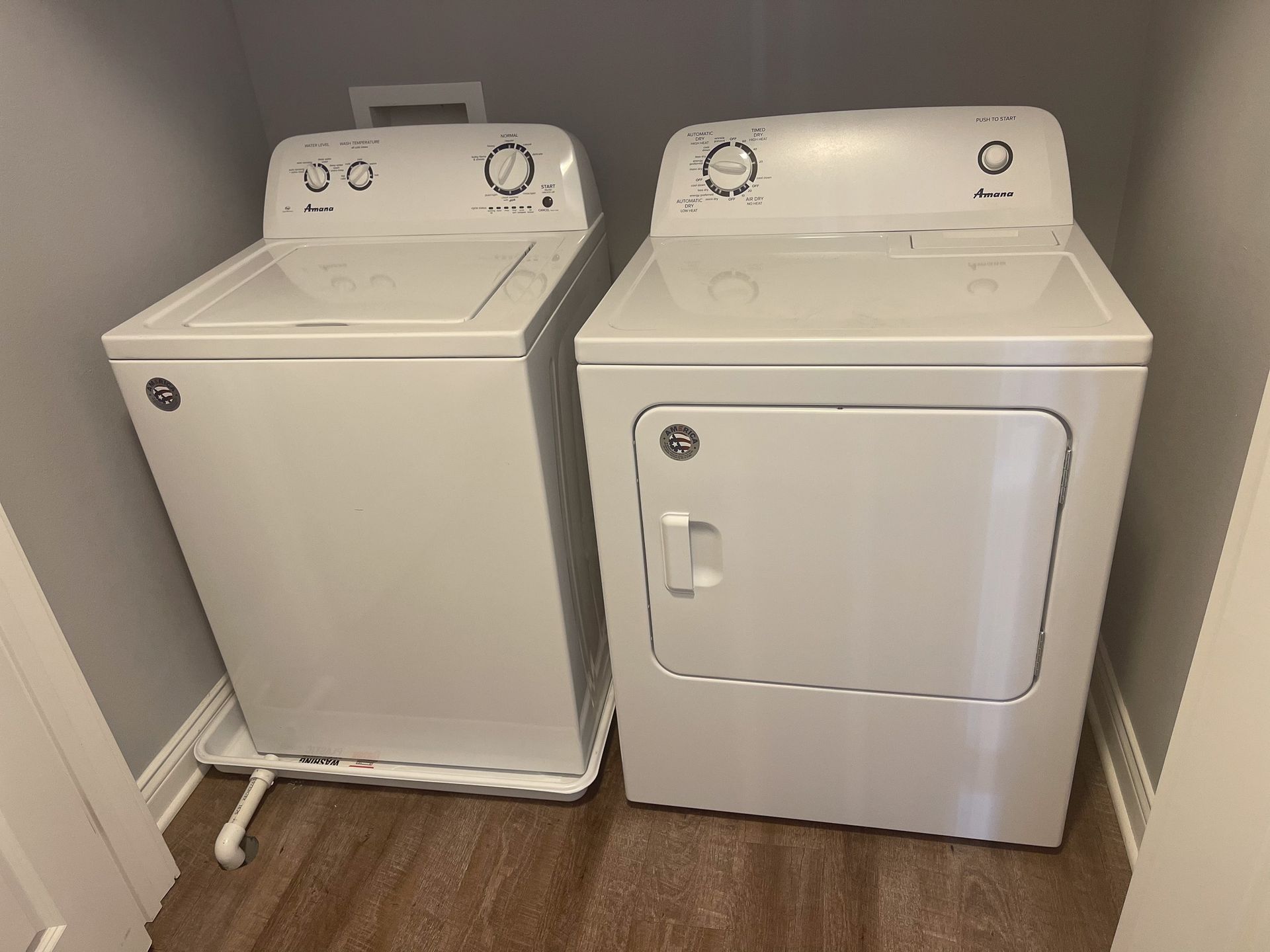 A washer and dryer are sitting next to each other in a laundry room.