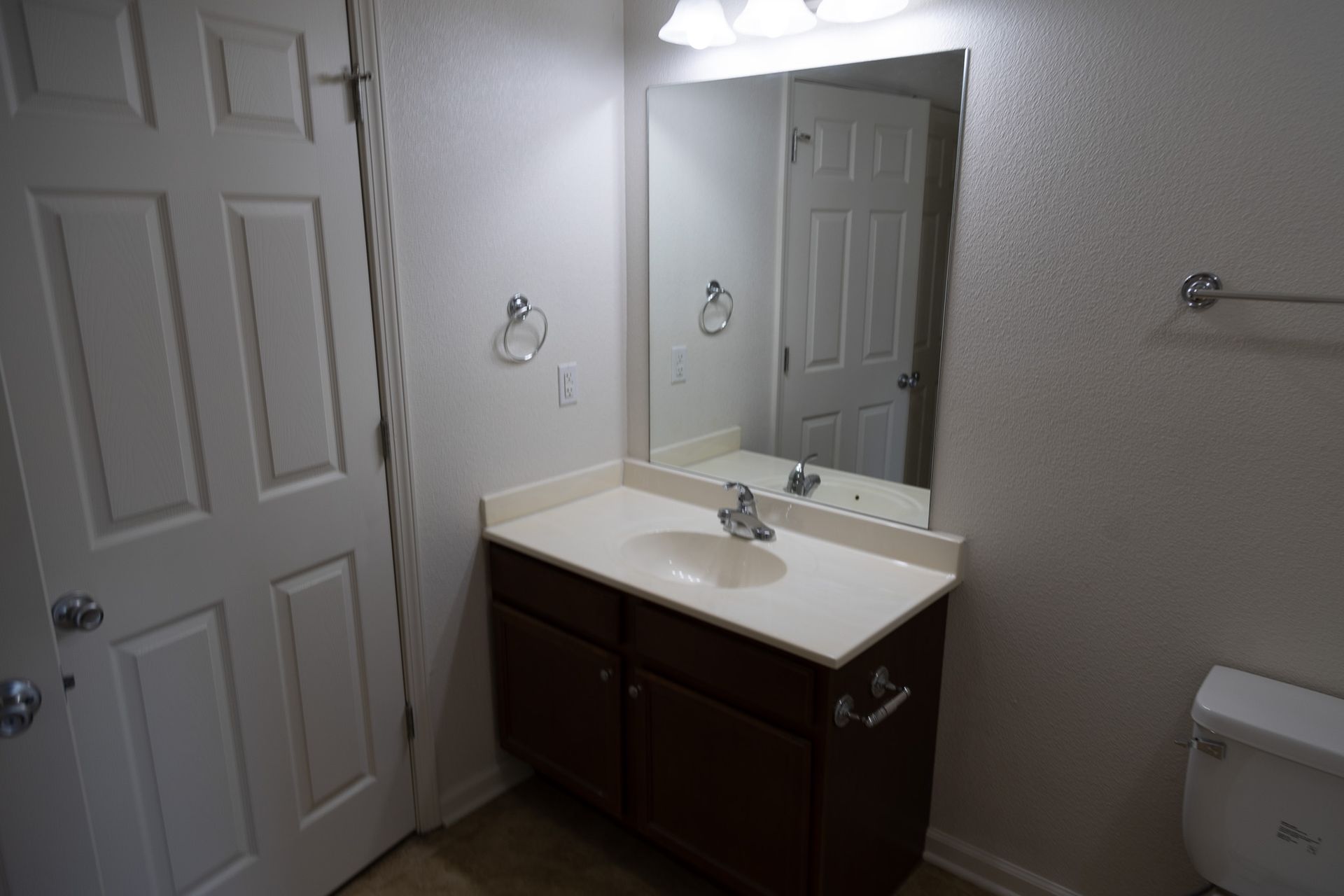 A bathroom with a sink , mirror and toilet