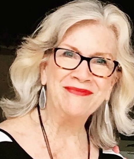 A close up of a woman wearing glasses and red lipstick.