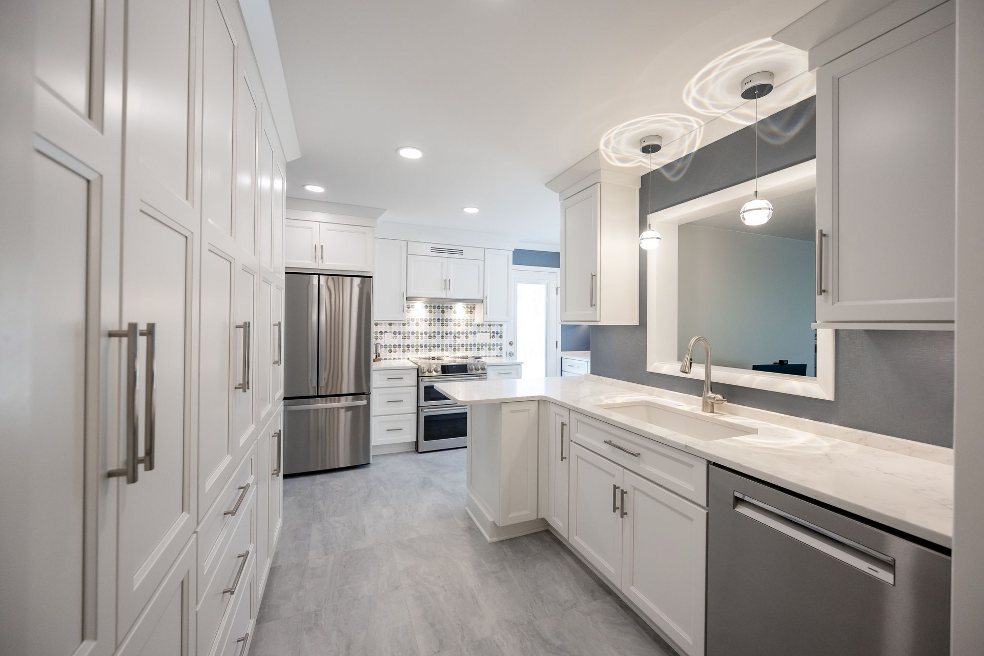 A kitchen with white cabinets and stainless steel appliances.