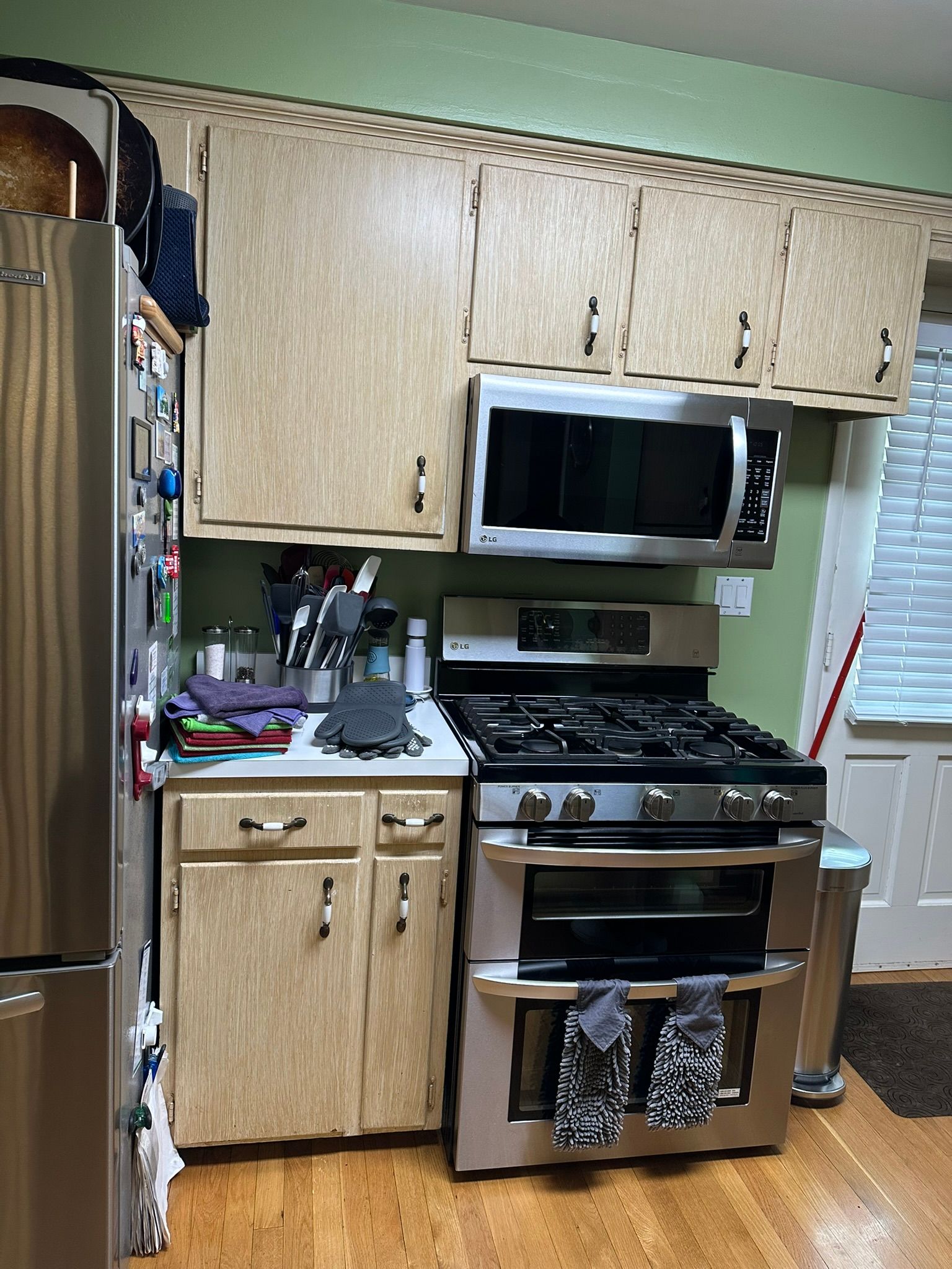 A kitchen with a refrigerator and stove.