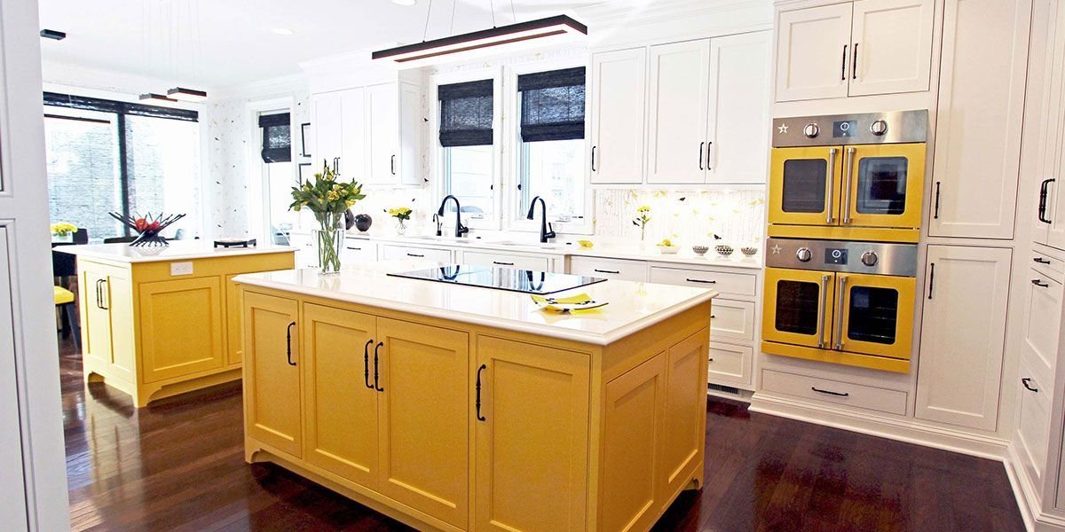 A kitchen with yellow cabinets and yellow appliances.