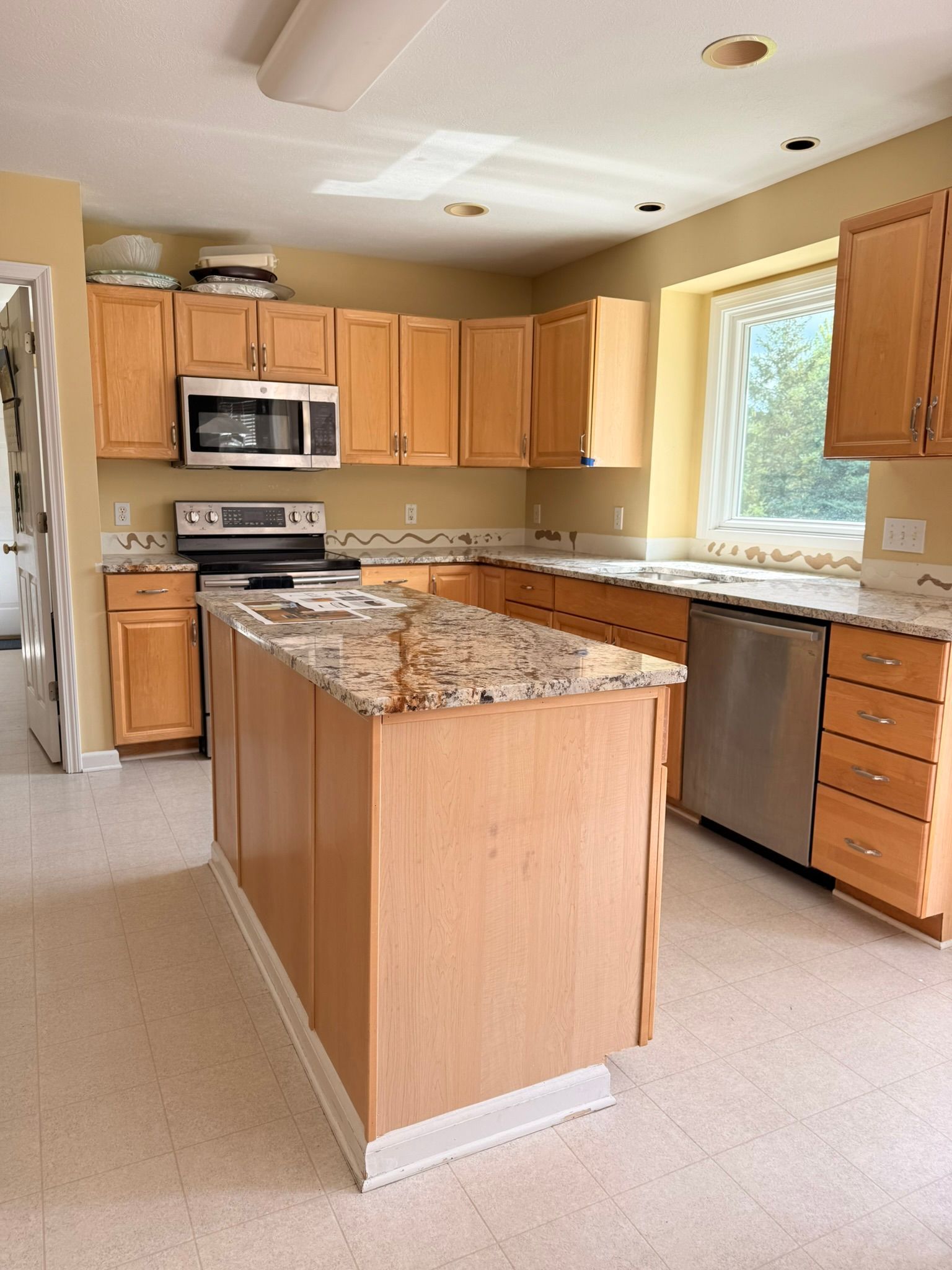 A kitchen with a refrigerator , stove , and sink.