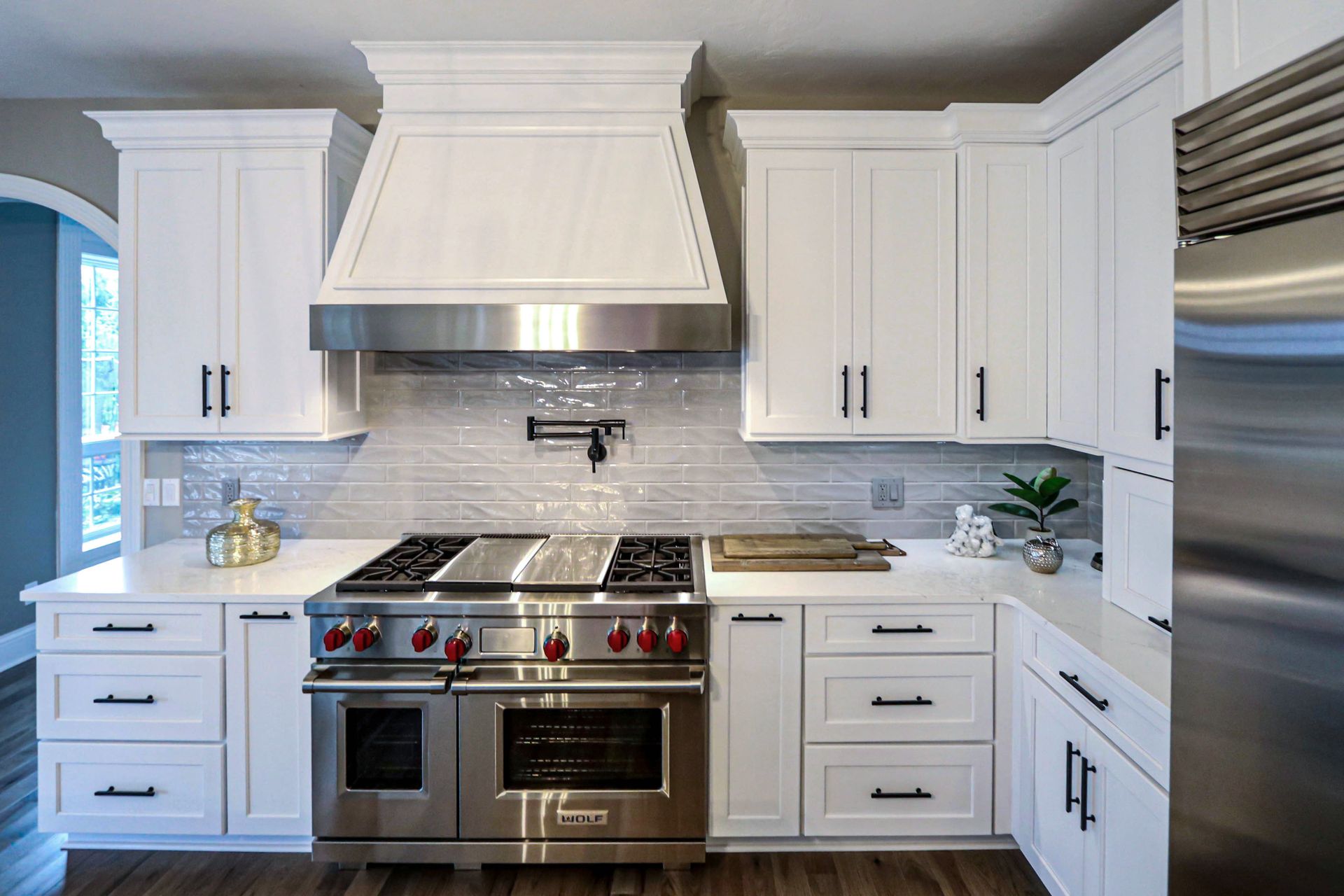 A kitchen with white cabinets and stainless steel appliances.
