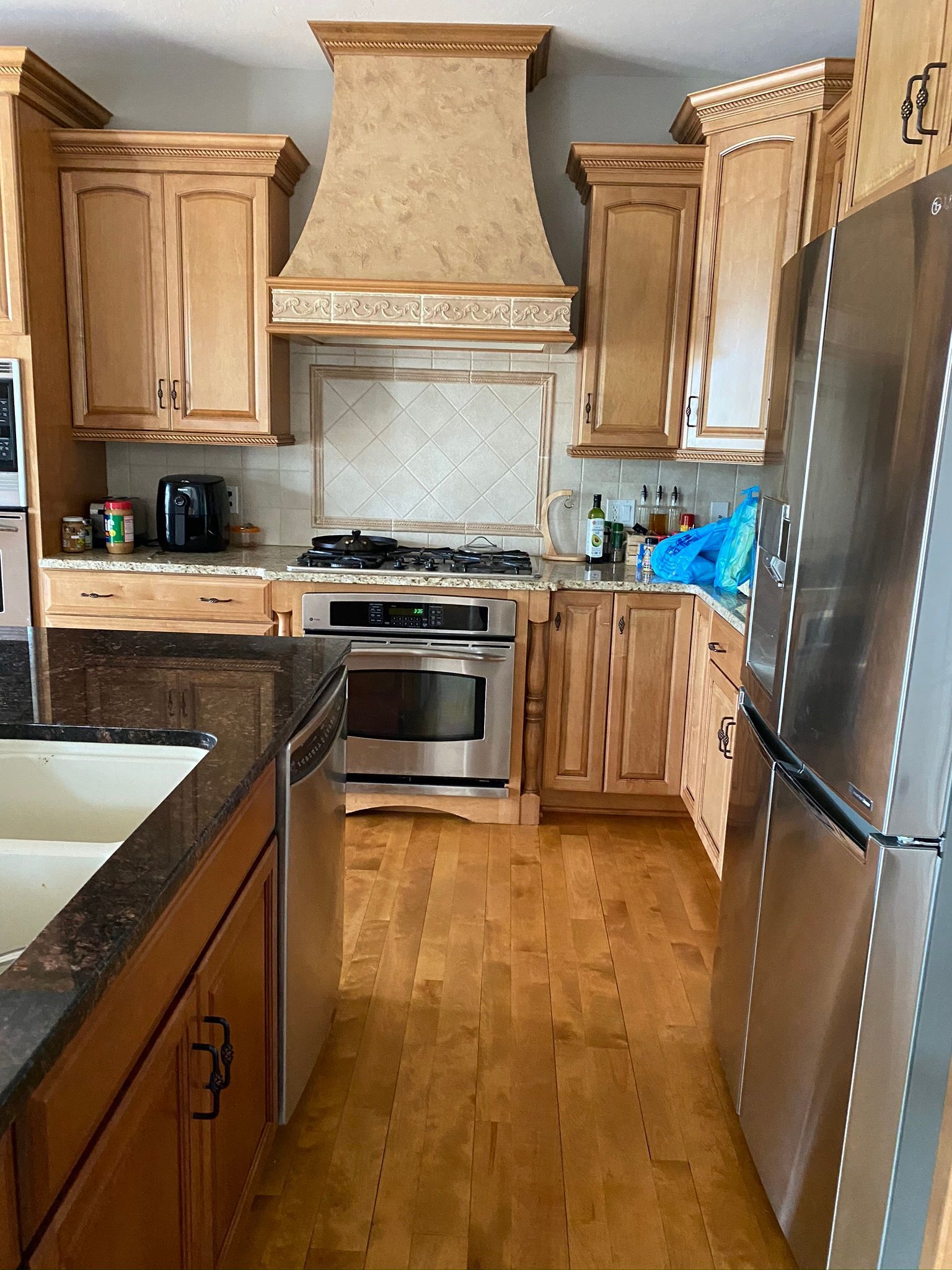 A kitchen with stainless steel appliances and wooden cabinets