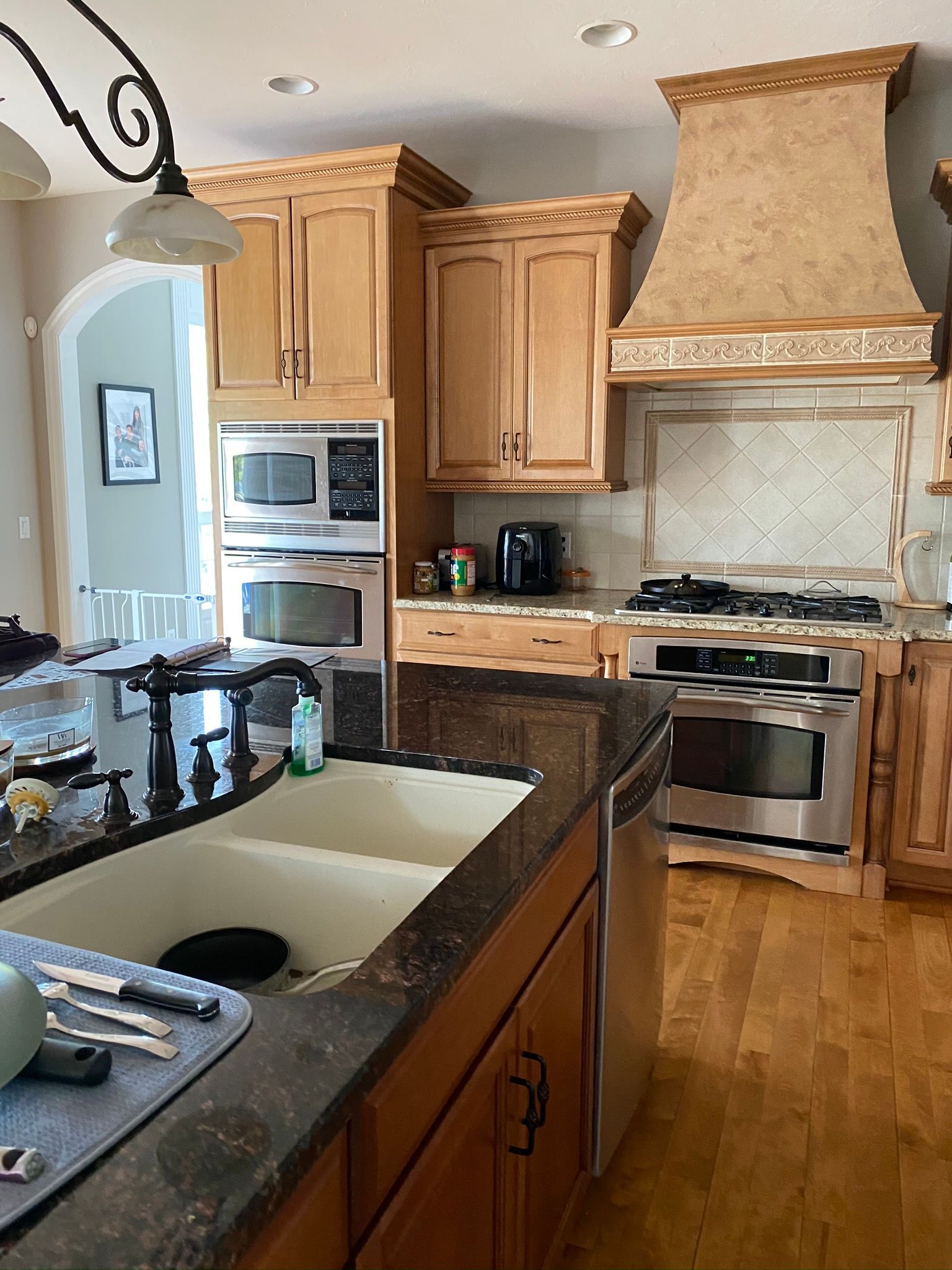 A kitchen with stainless steel appliances and wooden cabinets