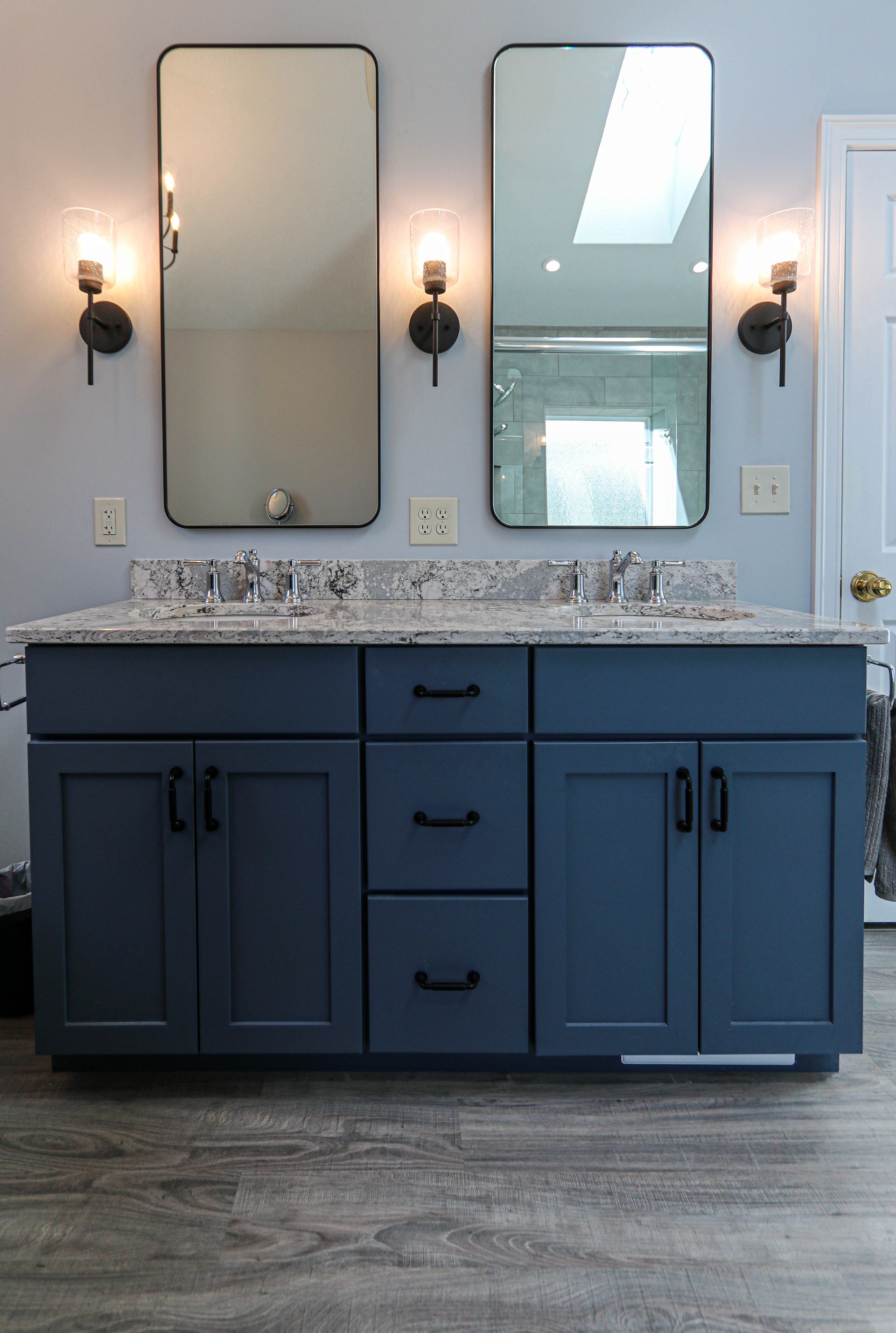A bathroom with two sinks and two mirrors.