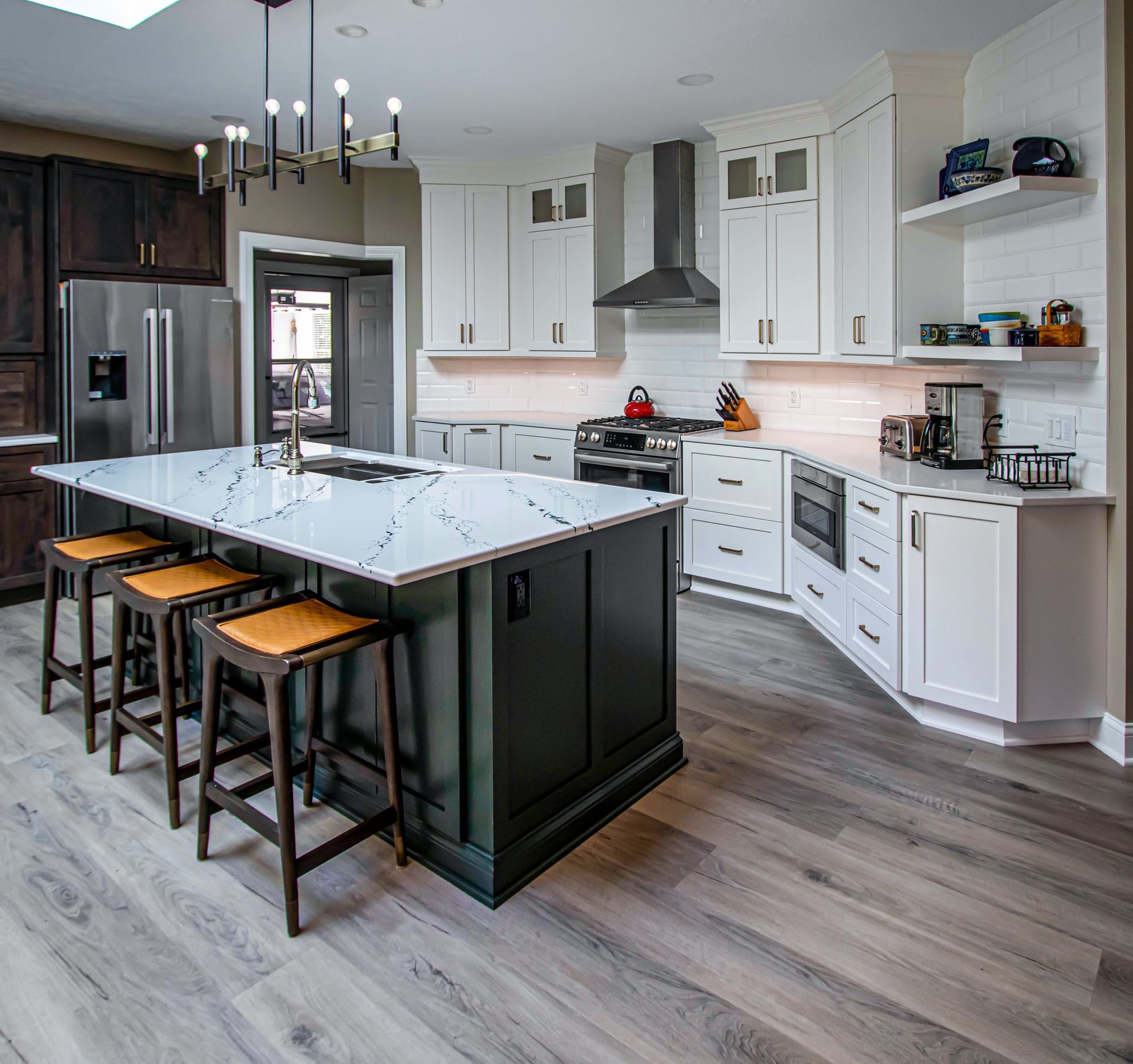 A kitchen with a large island and stools