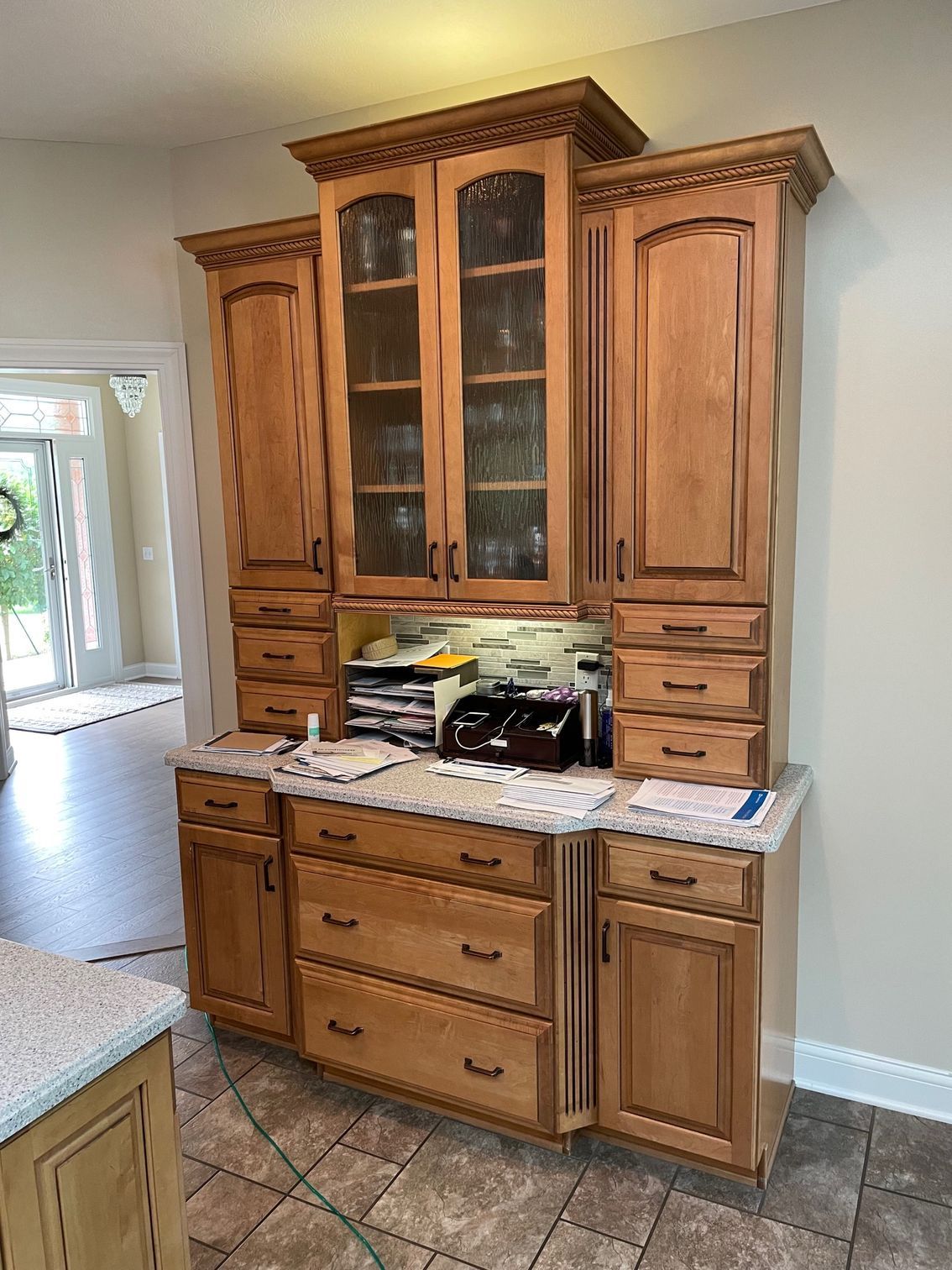 A kitchen with lots of wooden cabinets and drawers.