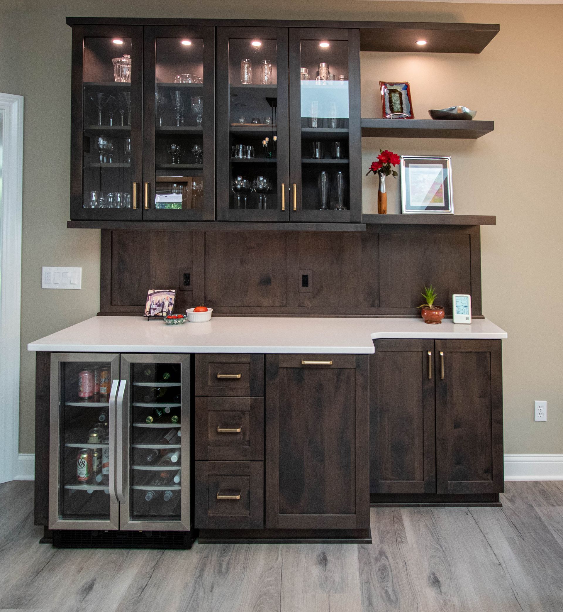 A kitchen with wooden cabinets and a wine cooler