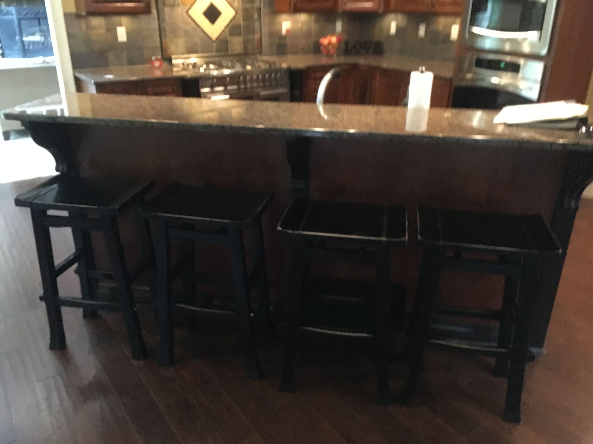 A kitchen with a bar and stools in it