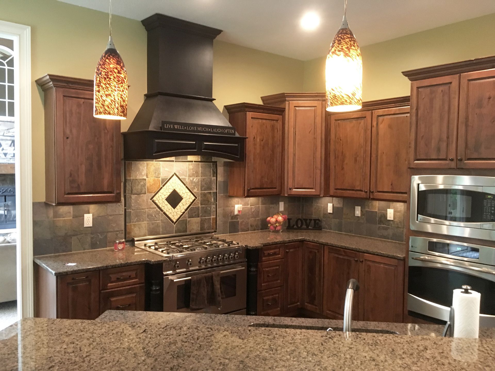 A kitchen with stainless steel appliances and wooden cabinets