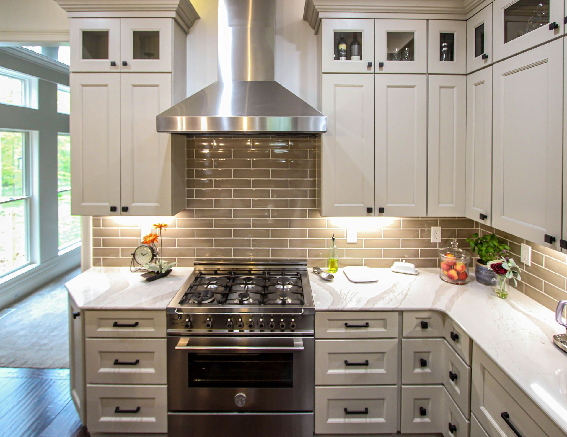 A kitchen with stainless steel appliances and white cabinets.