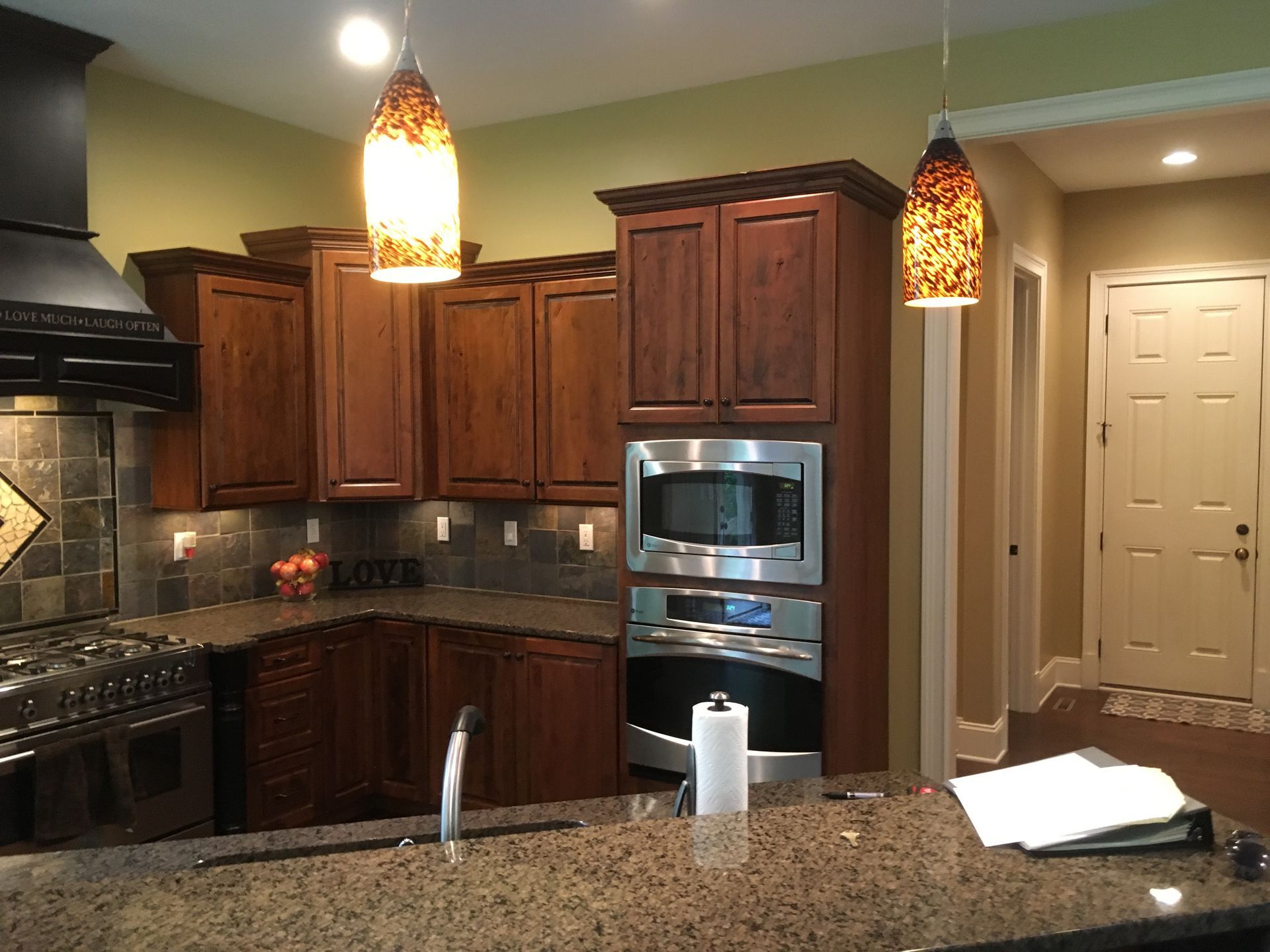 A kitchen with stainless steel appliances and wooden cabinets