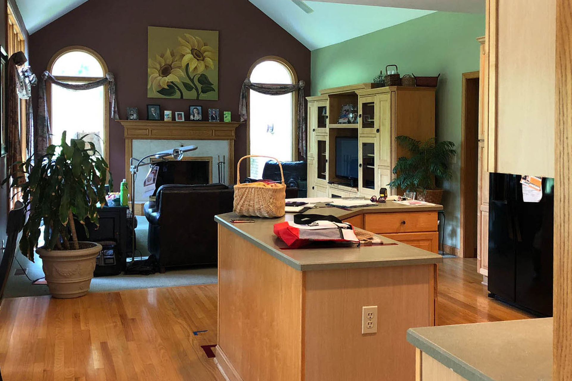 A living room with hardwood floors and a vaulted ceiling