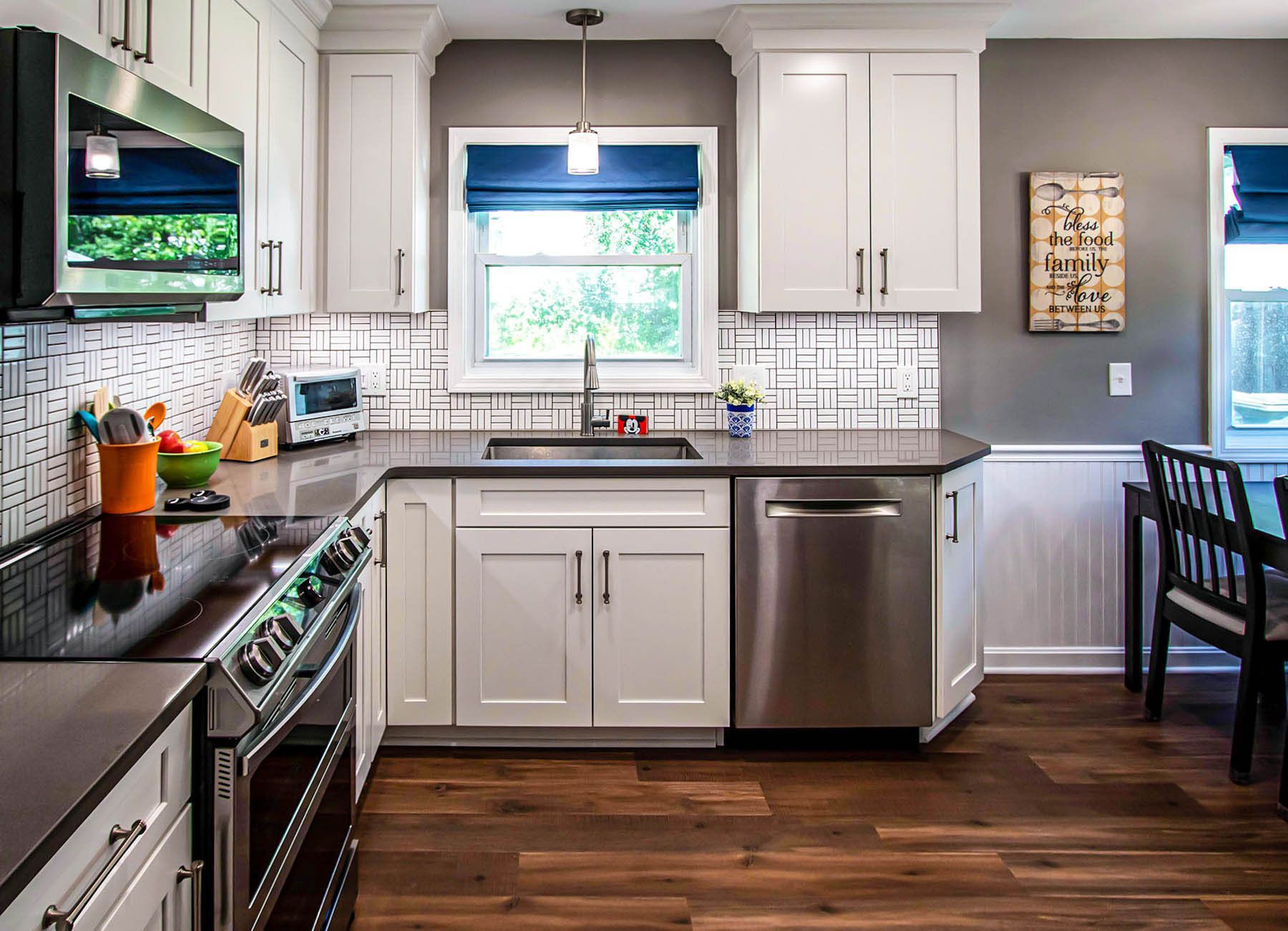 A kitchen with white cabinets and stainless steel appliances