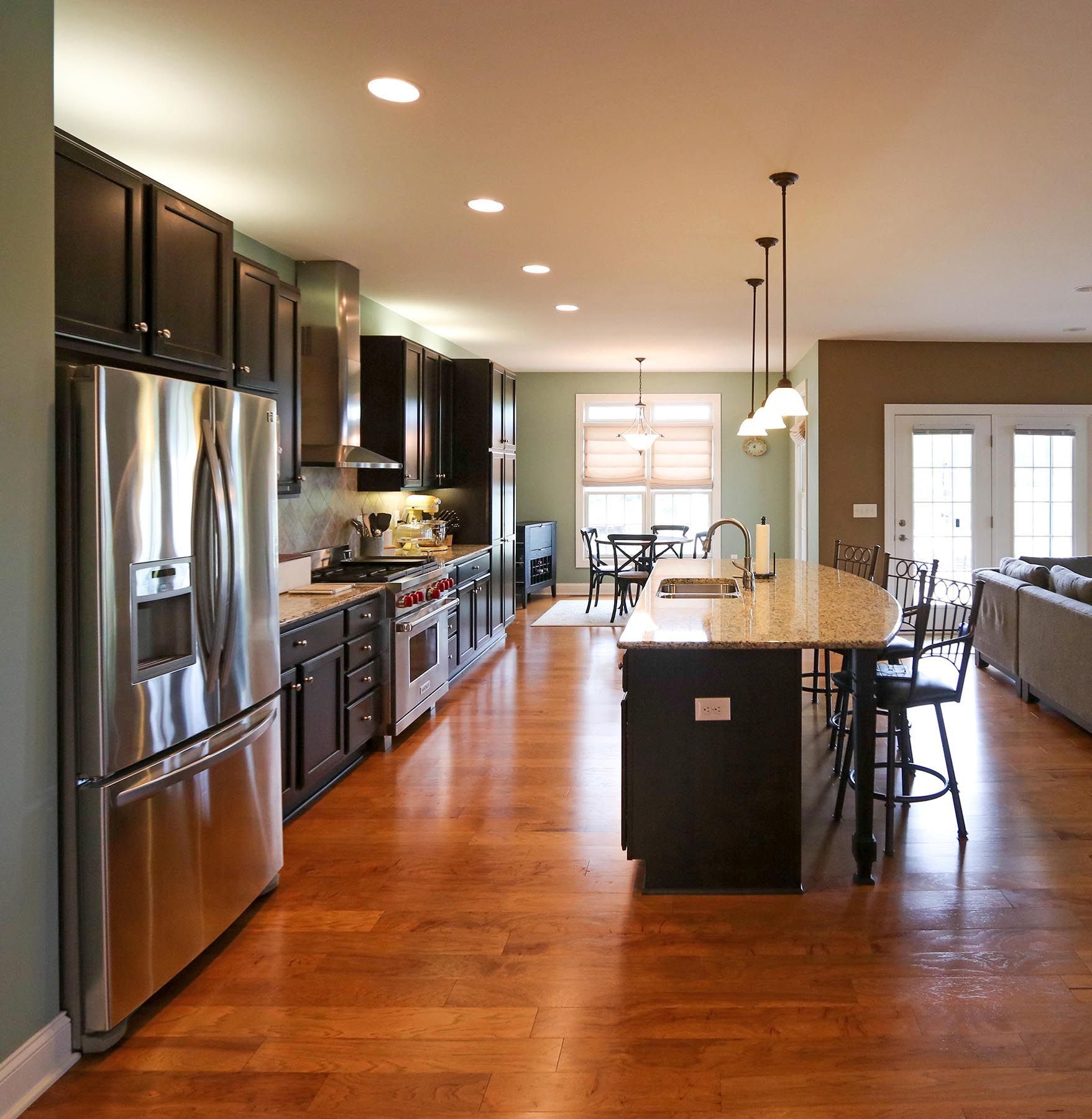 A kitchen with stainless steel appliances and a large island