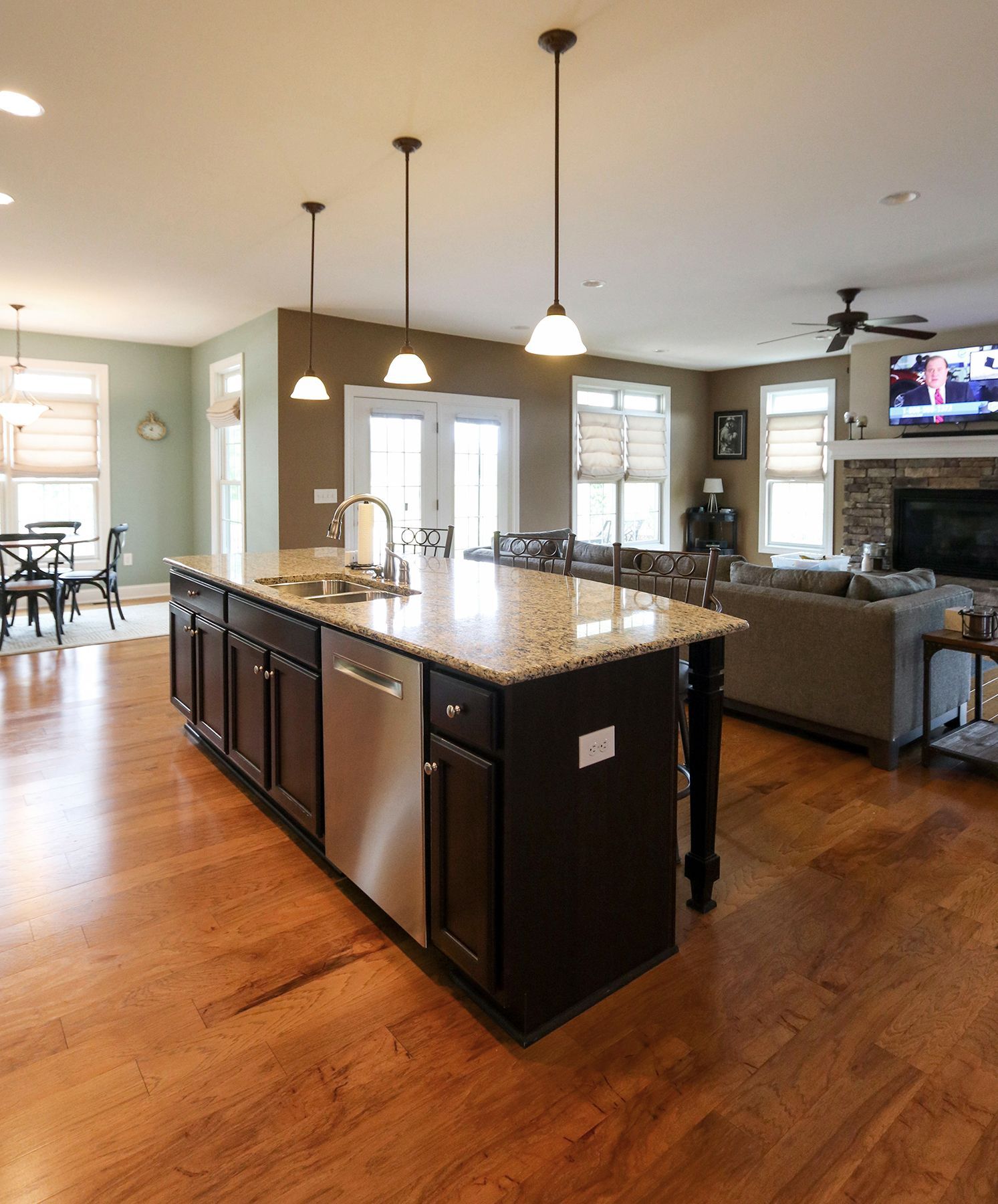 A kitchen with a large island and a stainless steel dishwasher
