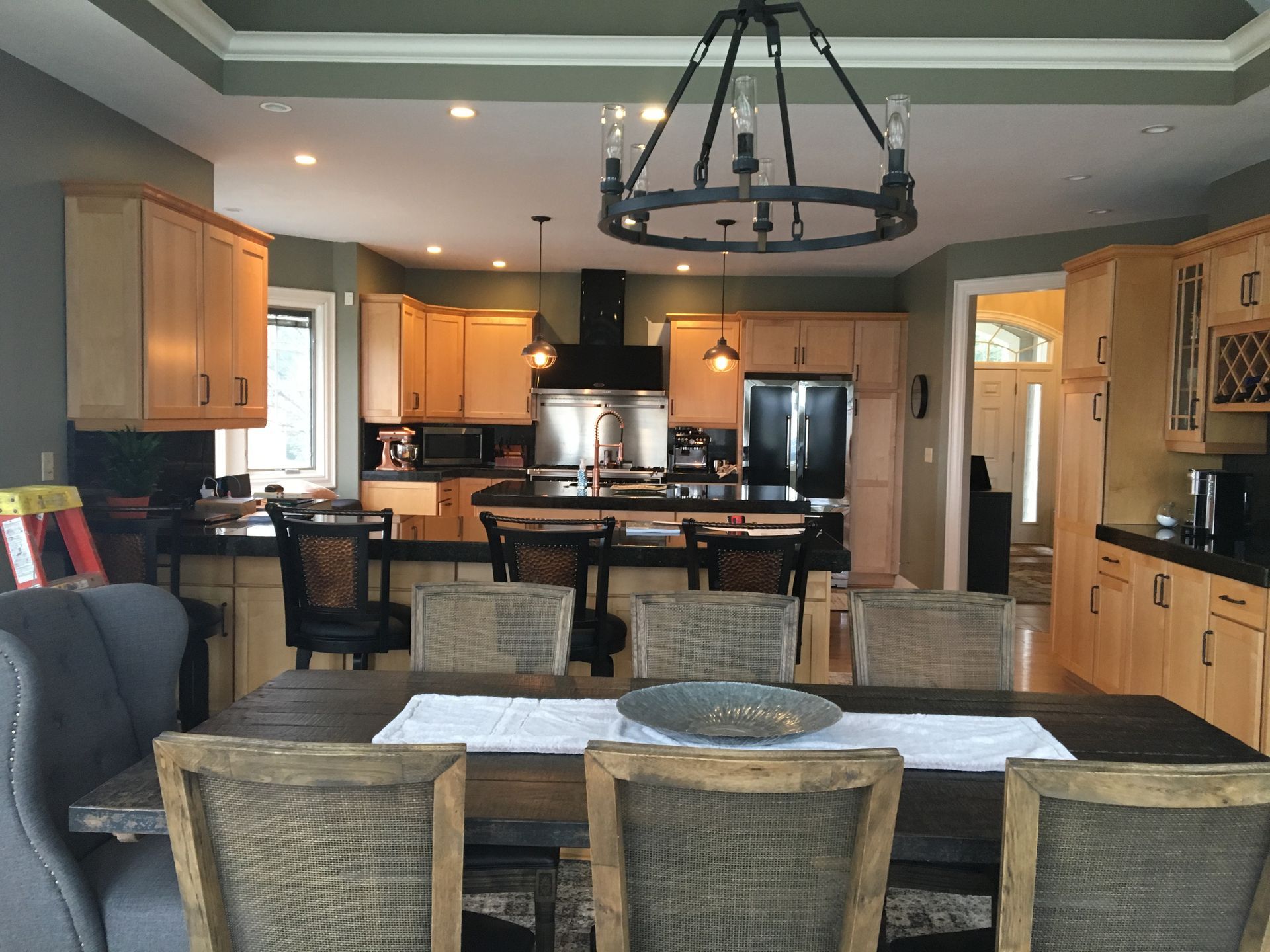 A kitchen with a table and chairs and a chandelier