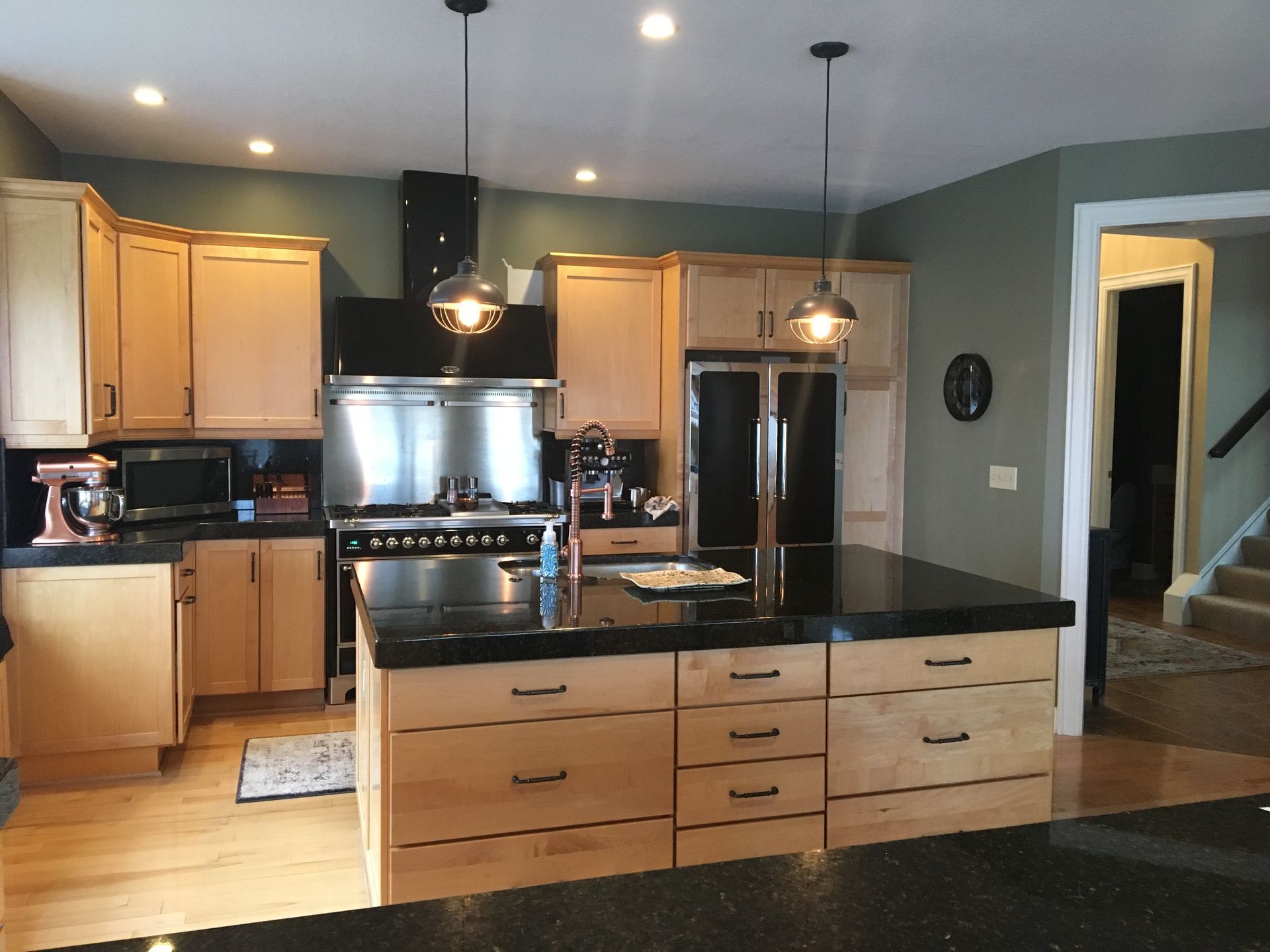 A kitchen with stainless steel appliances and wooden cabinets