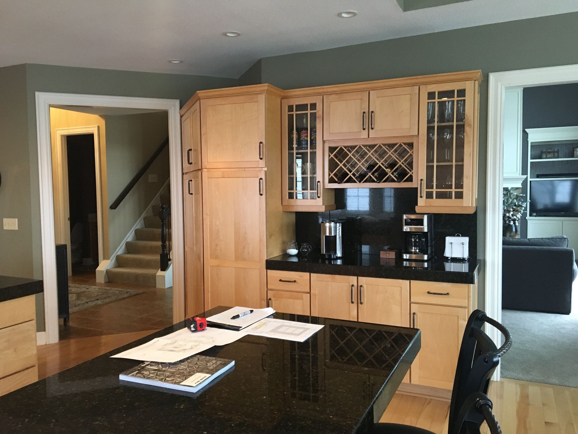 A kitchen with wooden cabinets and a wine rack