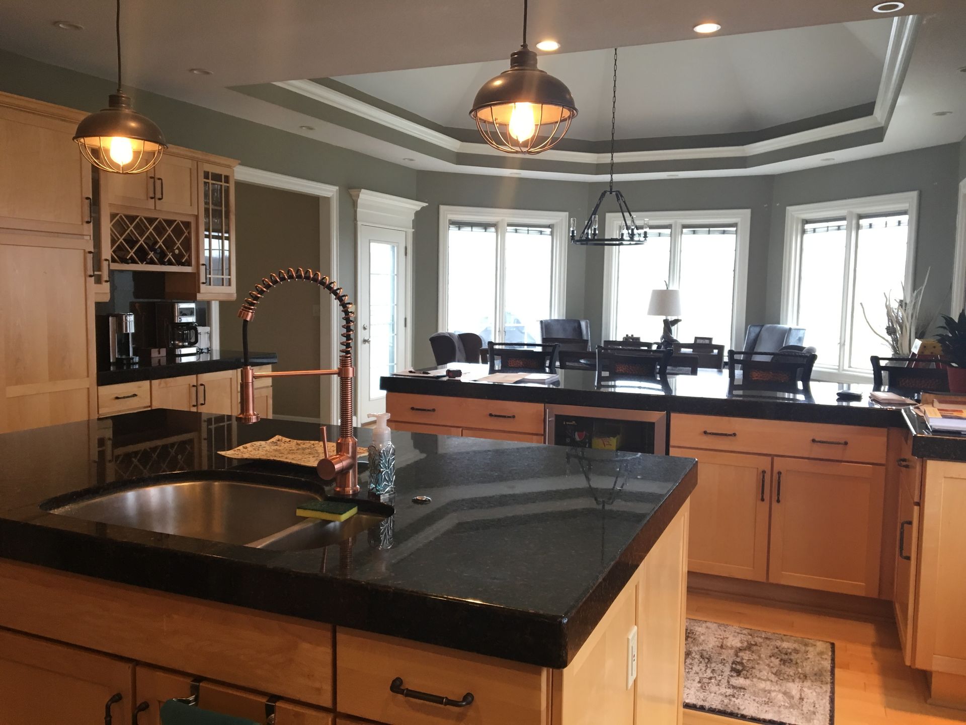 A kitchen with a large island and a sink.