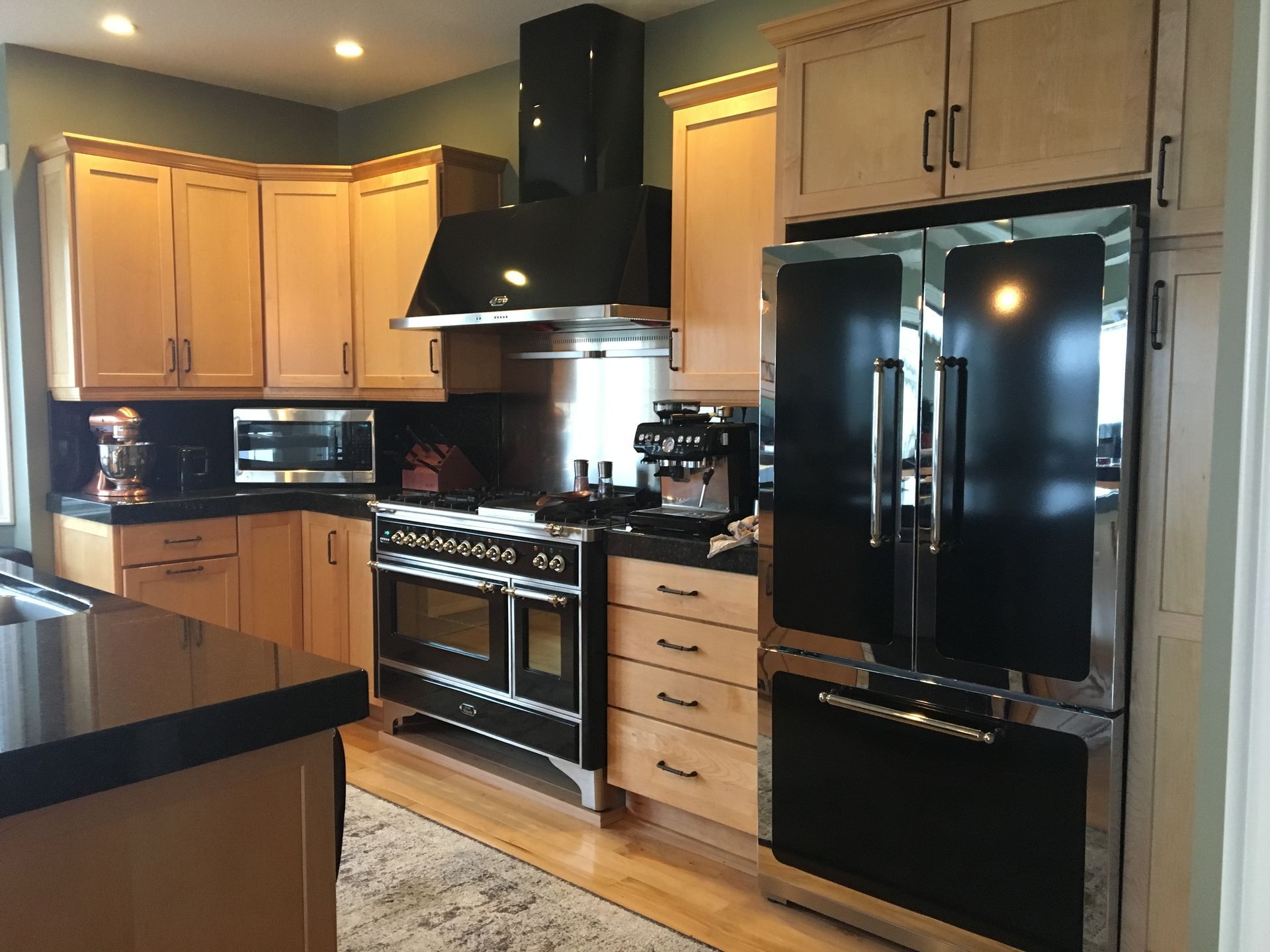 A kitchen with stainless steel appliances and wooden cabinets