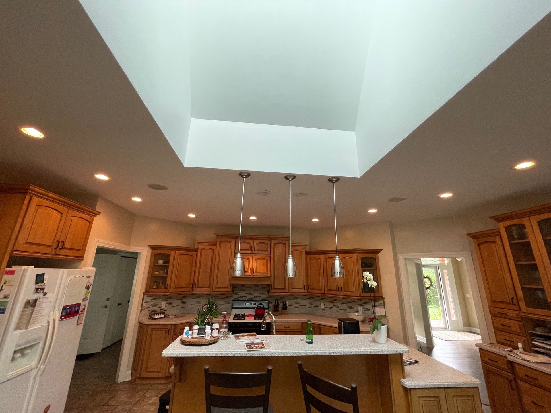 A kitchen with wooden cabinets and a white refrigerator.
