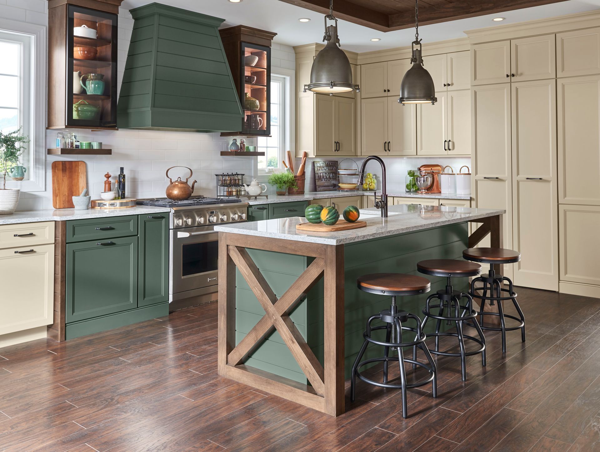 A kitchen with green cabinets , white cabinets , and a large island.