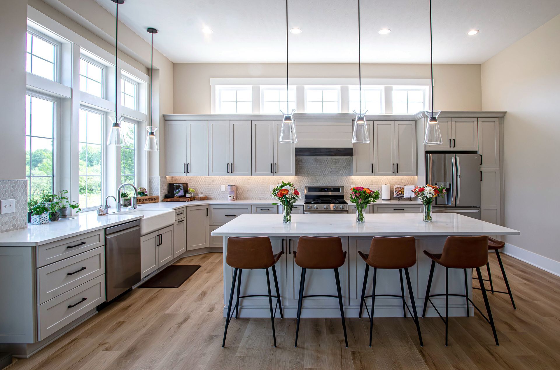 A large kitchen with a large island and stools.