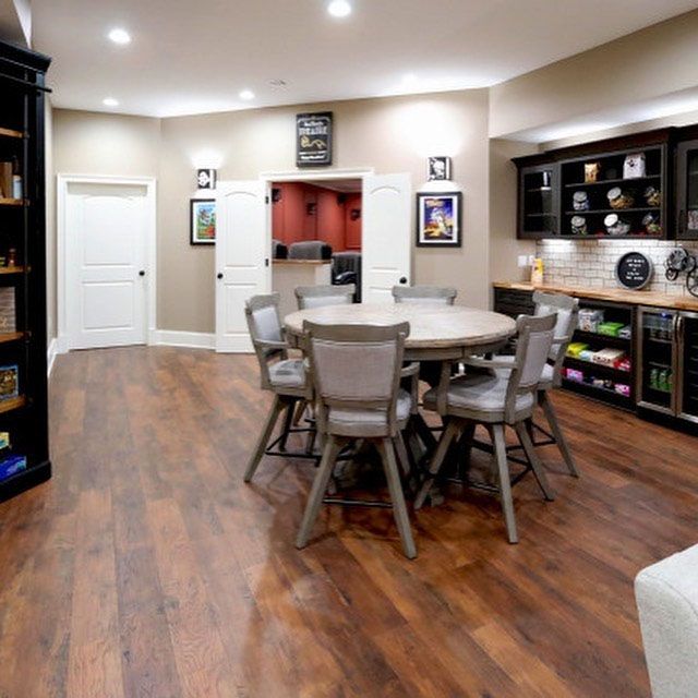 A dining room with a round table and chairs