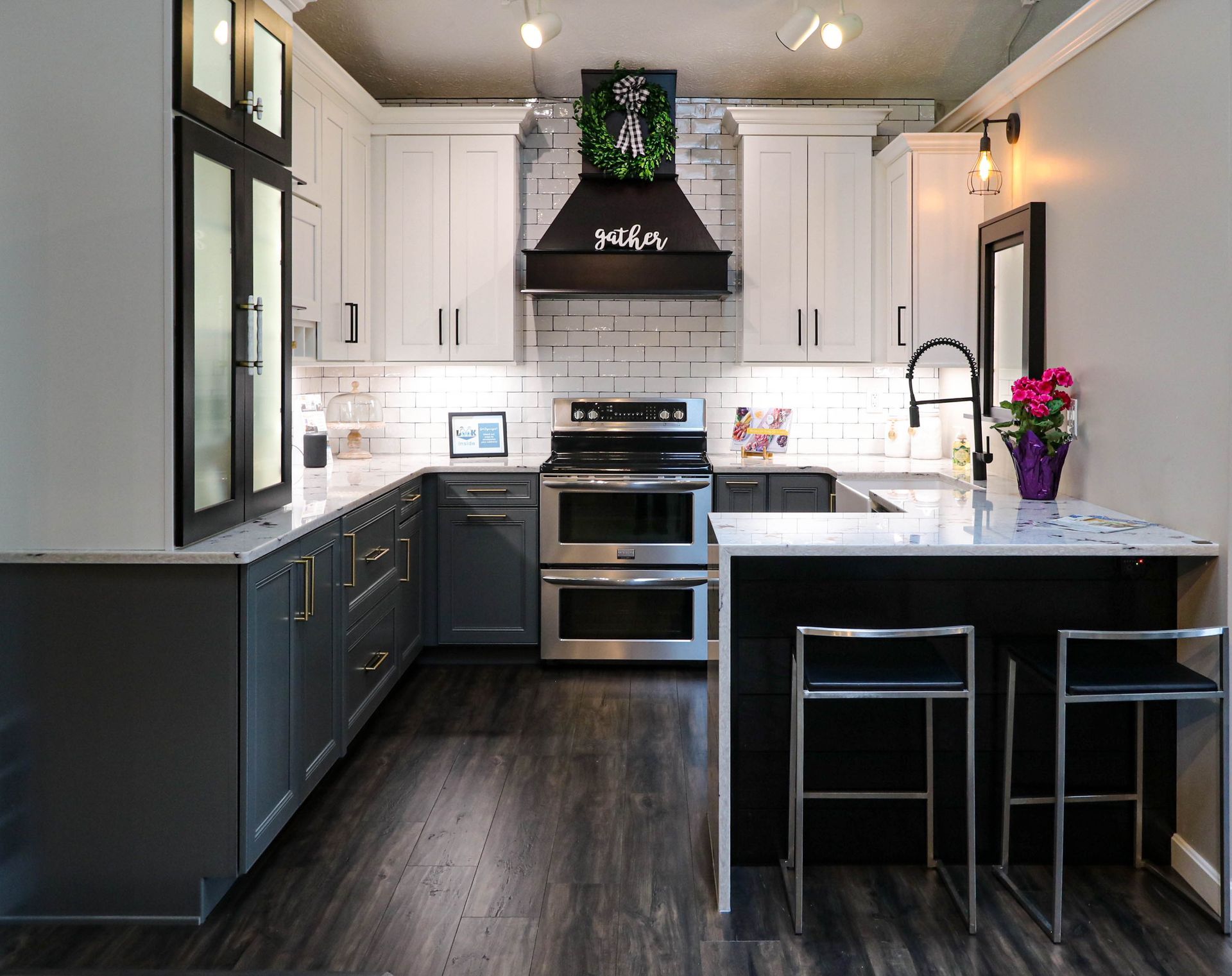 A kitchen with stainless steel appliances and black cabinets