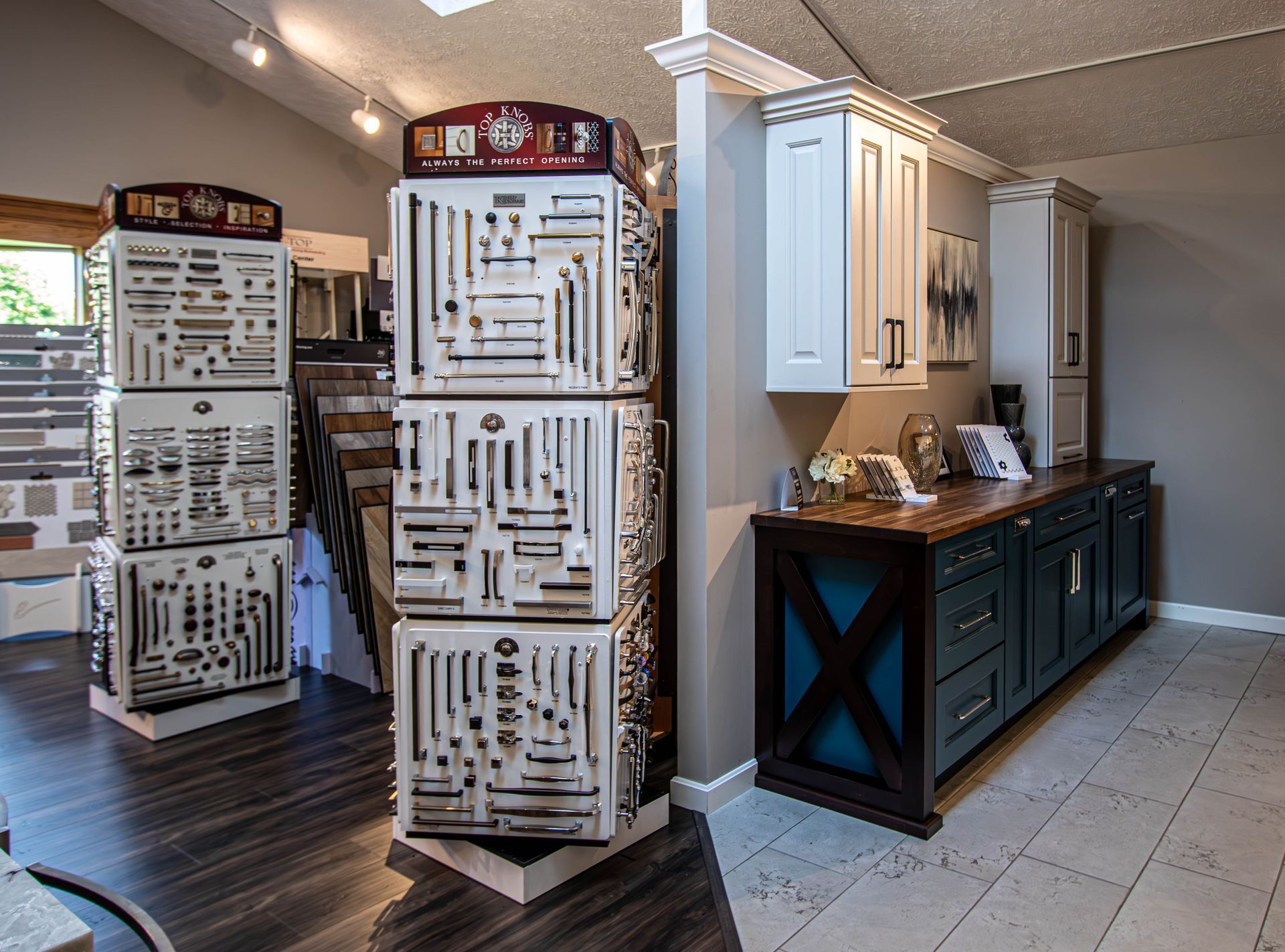 A kitchen with a lot of cabinets and a display of hardware.