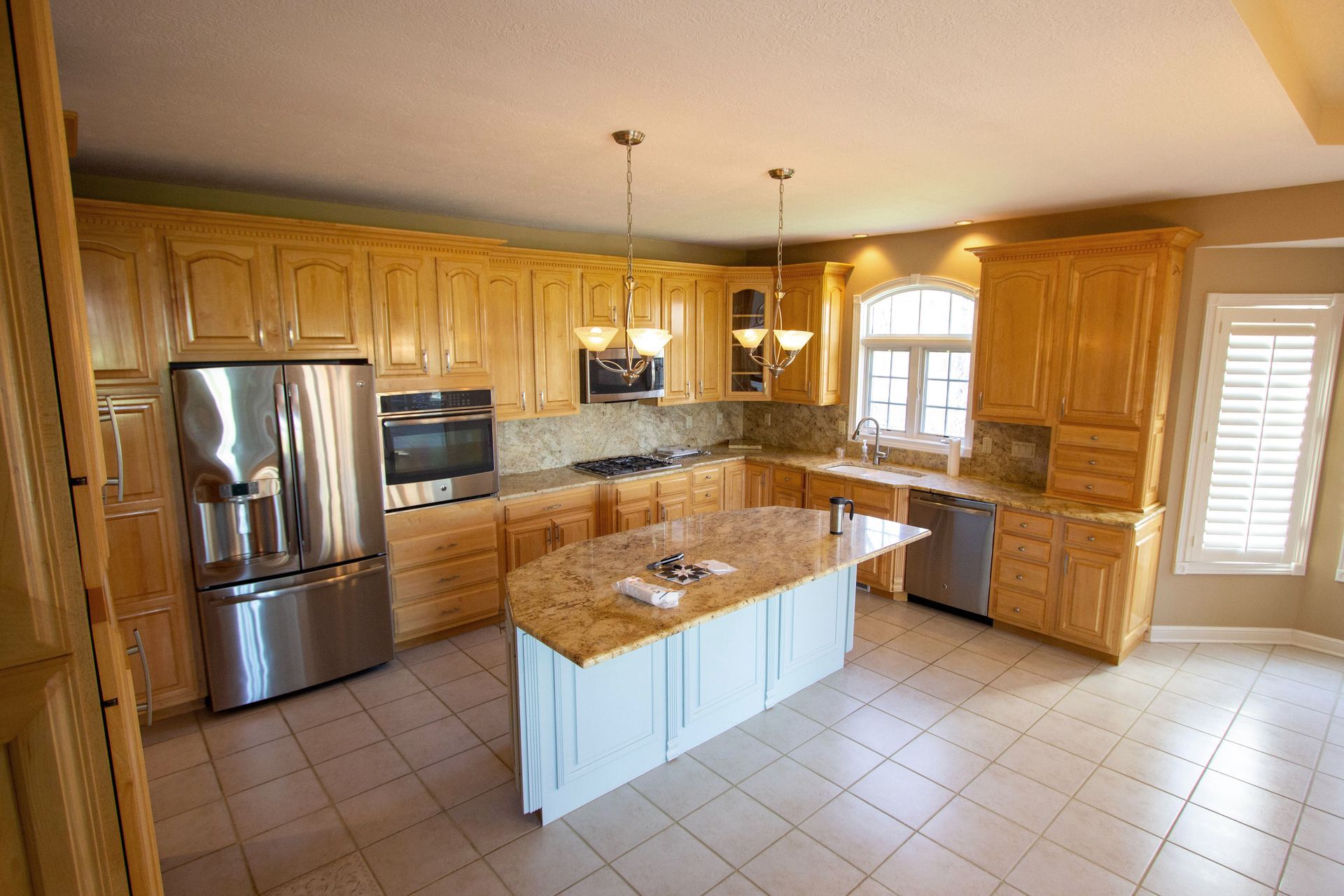 A kitchen with stainless steel appliances and wooden cabinets
