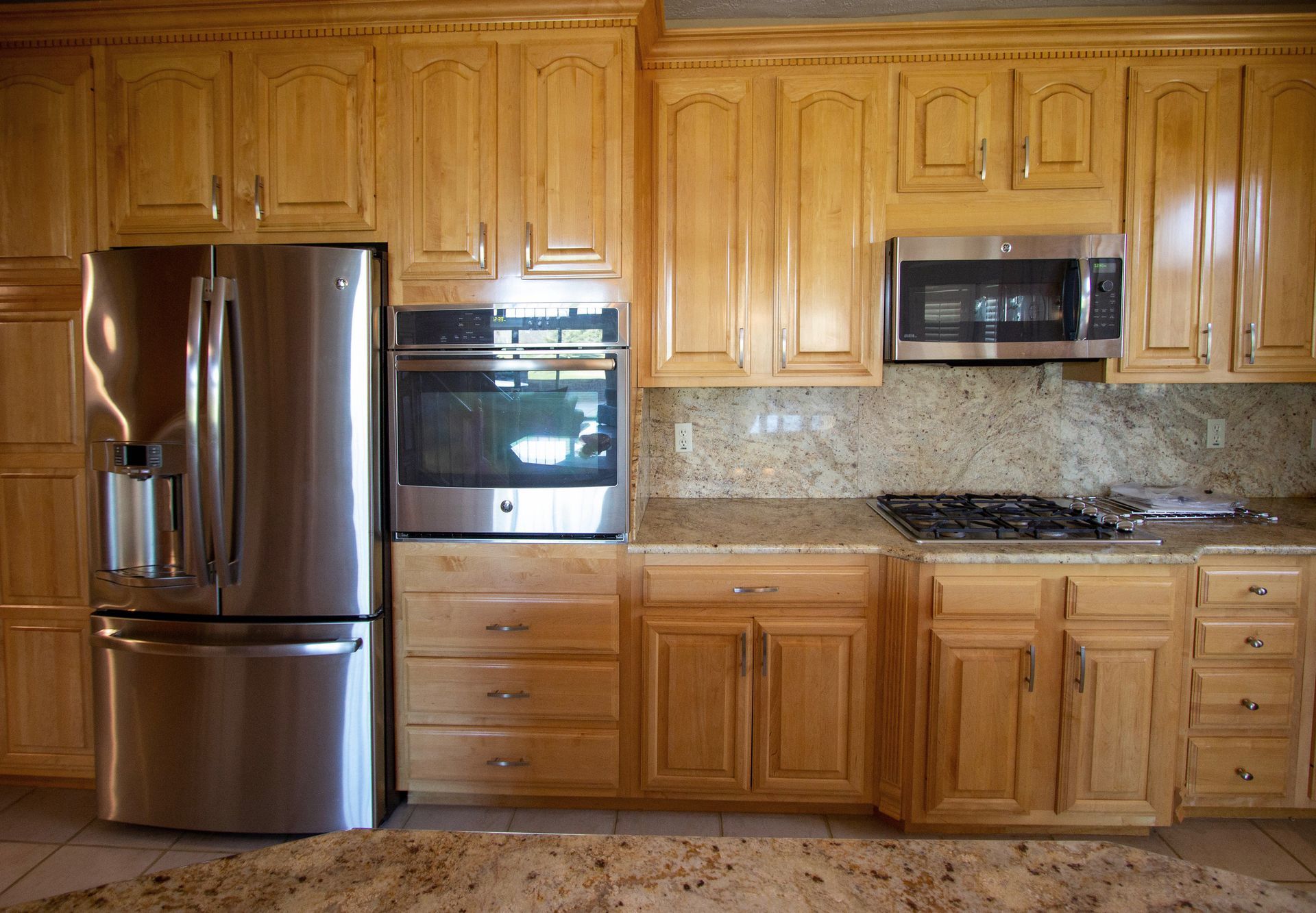A kitchen with stainless steel appliances and wooden cabinets