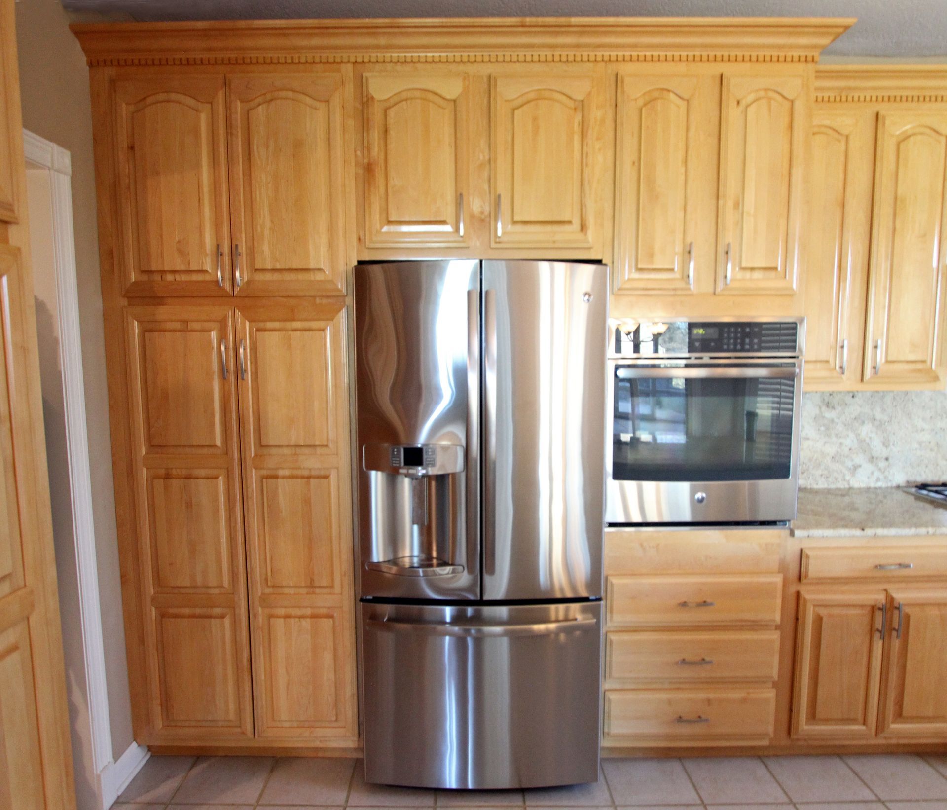 A kitchen with stainless steel appliances and wooden cabinets