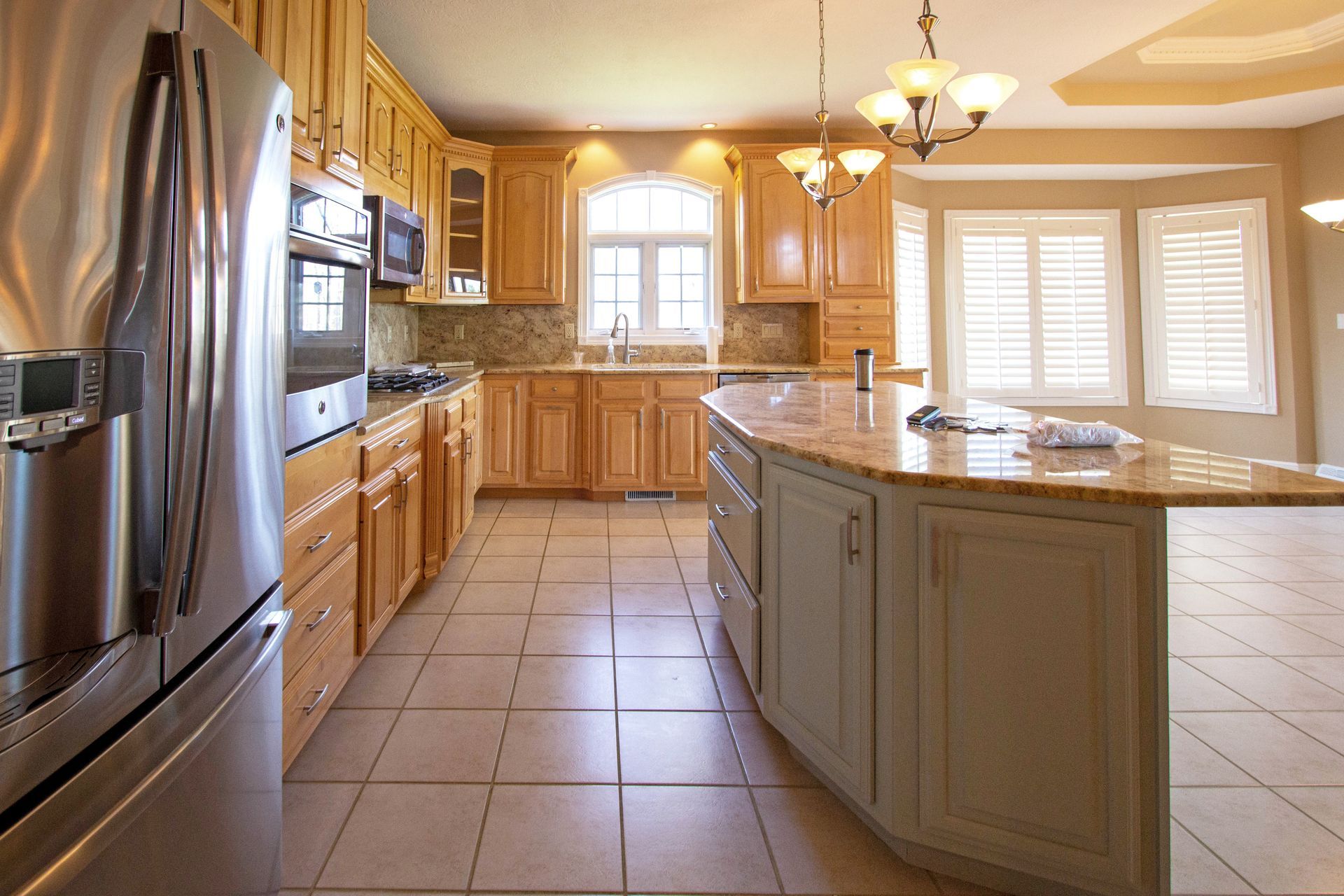 A kitchen with stainless steel appliances and wooden cabinets