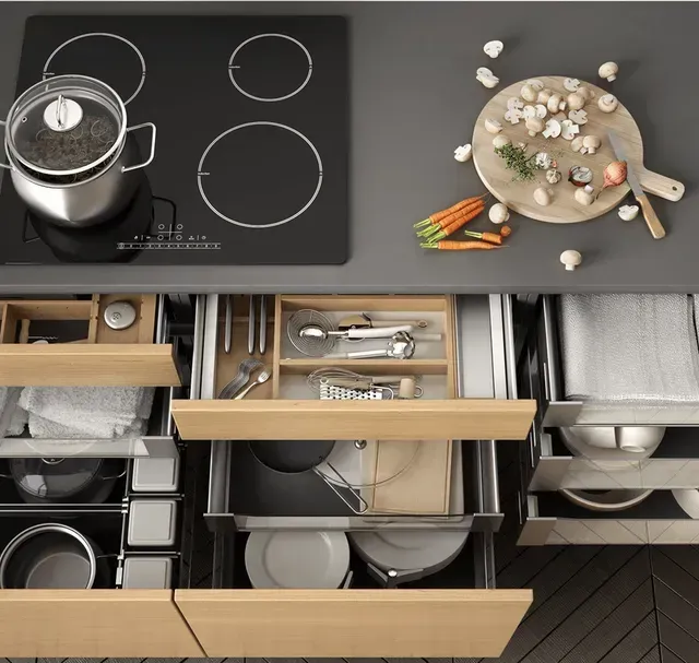 A kitchen counter with a pot and a cutting board on it
