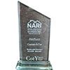 A trophy is sitting on top of a glass base on a white background.