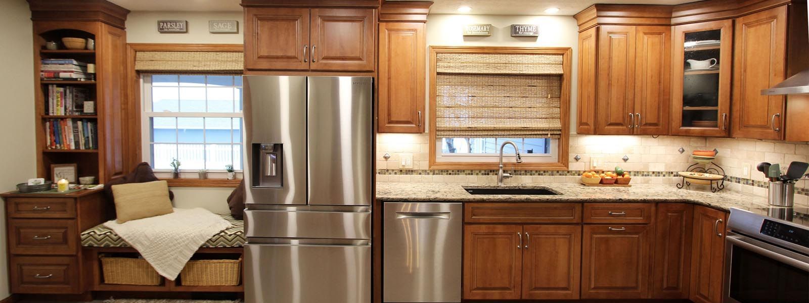 A kitchen with stainless steel appliances and wooden cabinets.