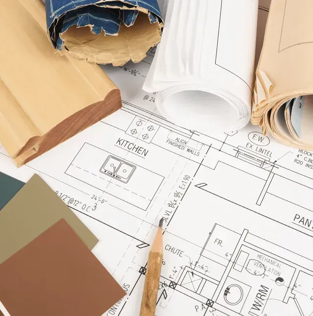 A blueprint of a kitchen is laying on a table