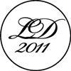A black and white logo with the year 2011 in a circle.