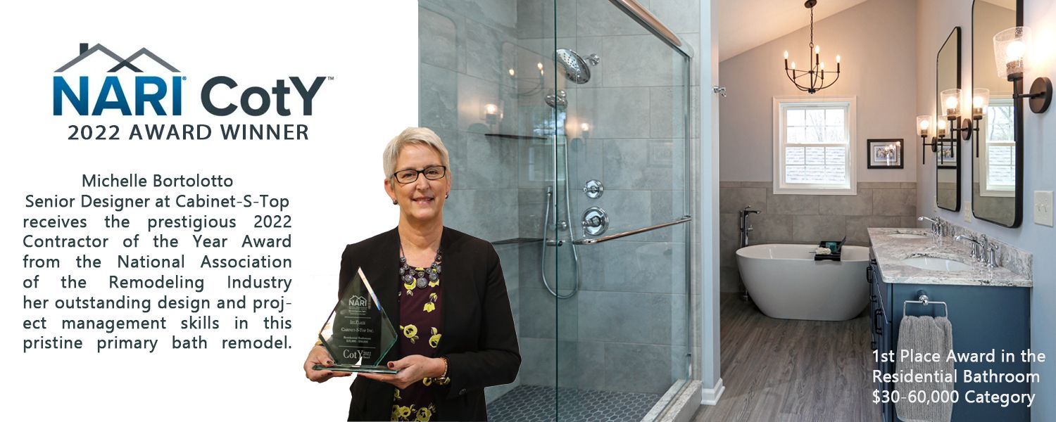 A woman is holding an award in front of a bathroom.